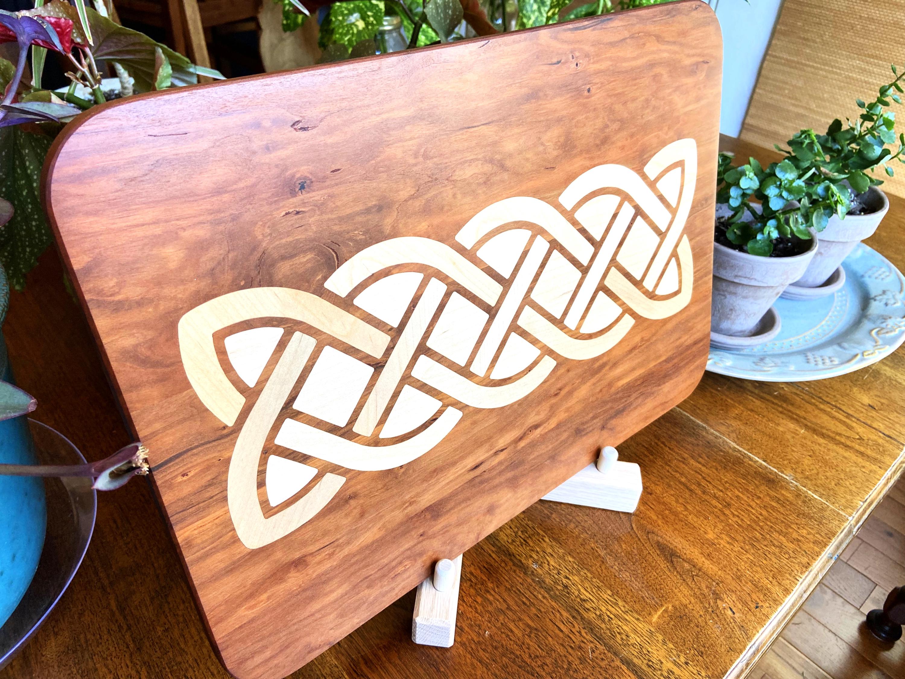 Cherry charcuterie board with complex Celtic knot inlay on White Oak wood