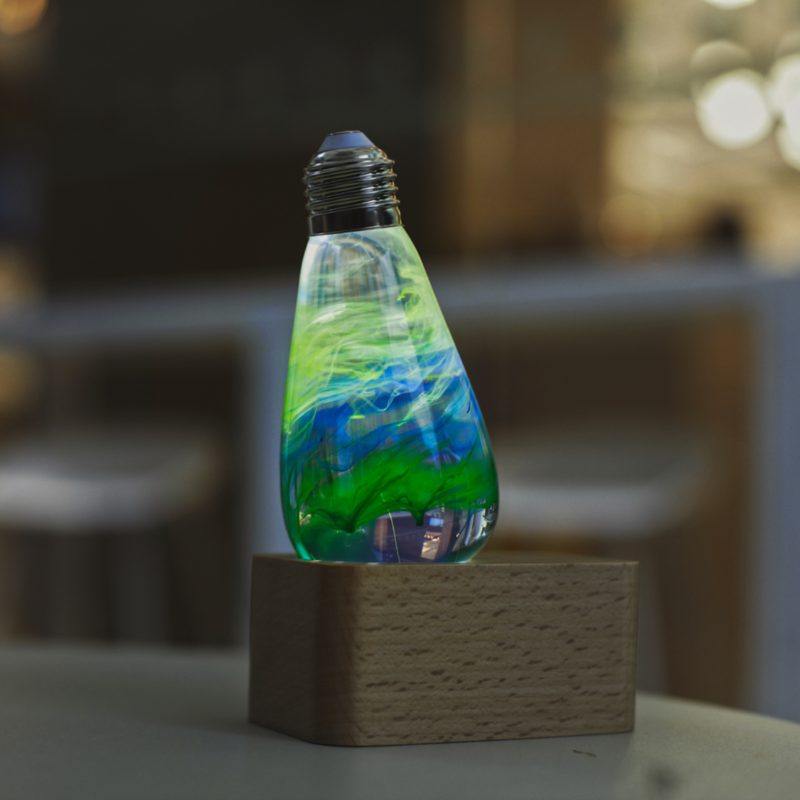 EP Light Spring Resin LED Bulb with green resin design on wooden base