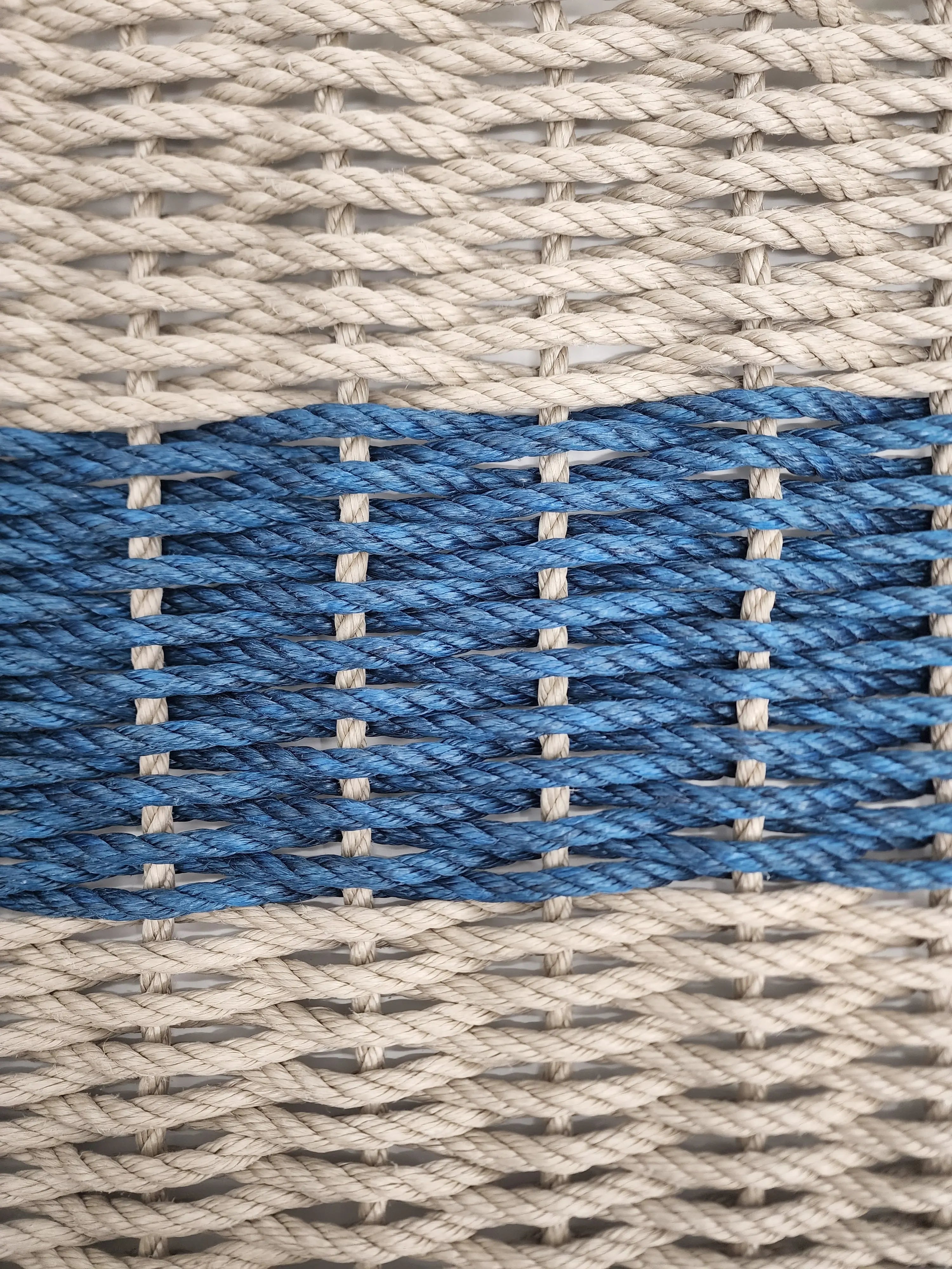 Handmade lobster rope mat in tan and navy blue colors