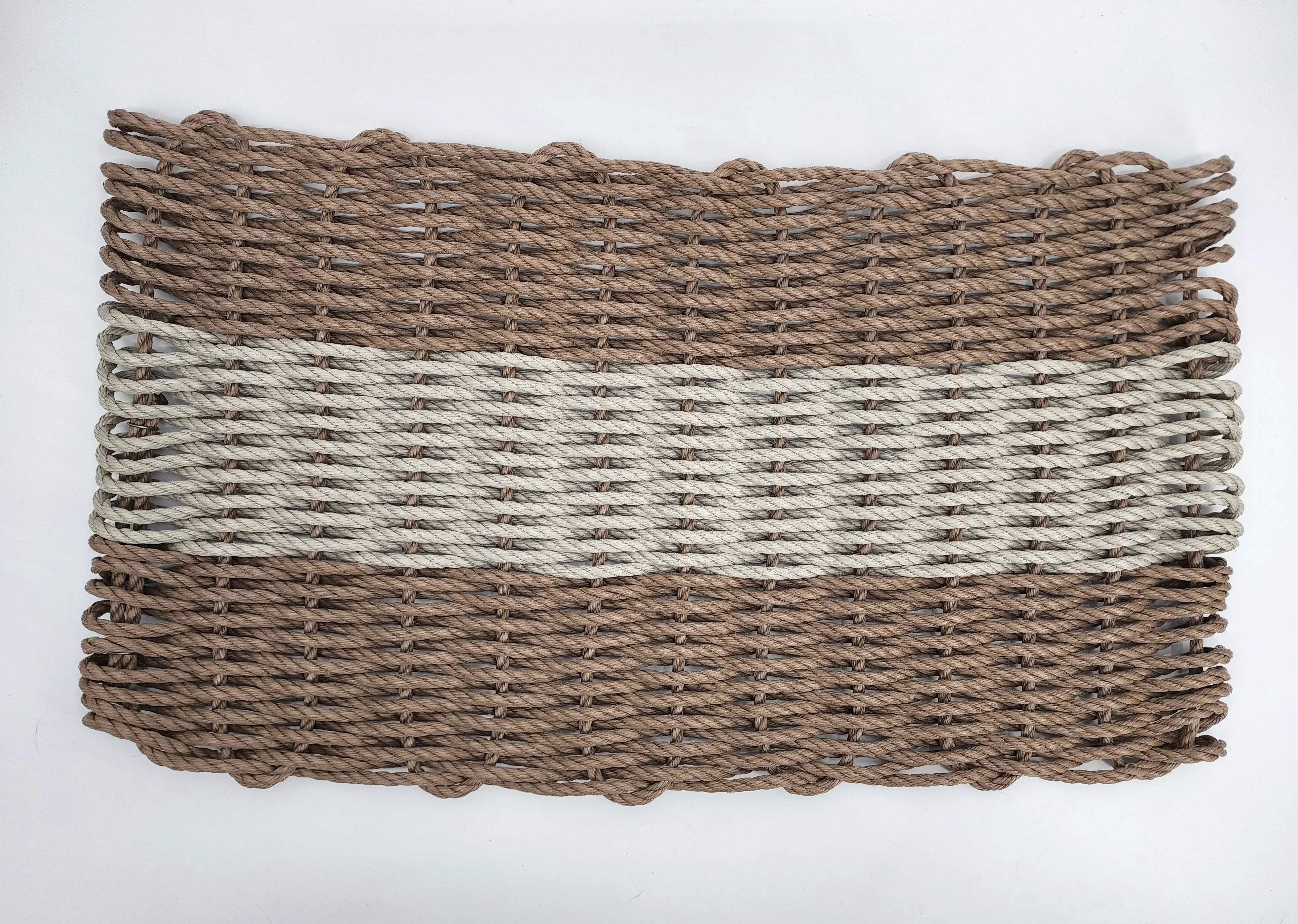 Handmade brown and tan lobster rope mat on wooden floor