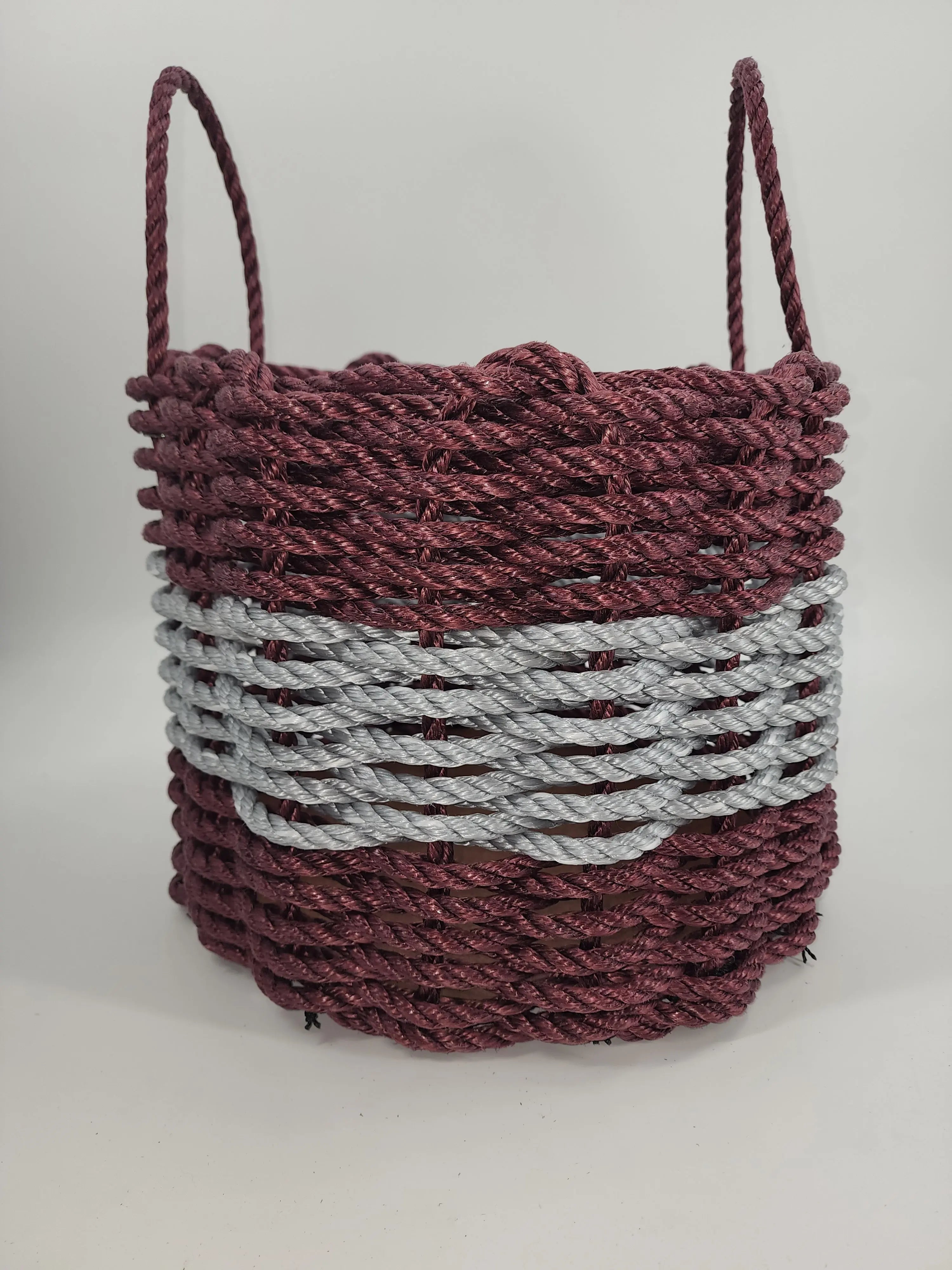 Handmade storage basket woven from burgundy and light gray Maine lobster rope