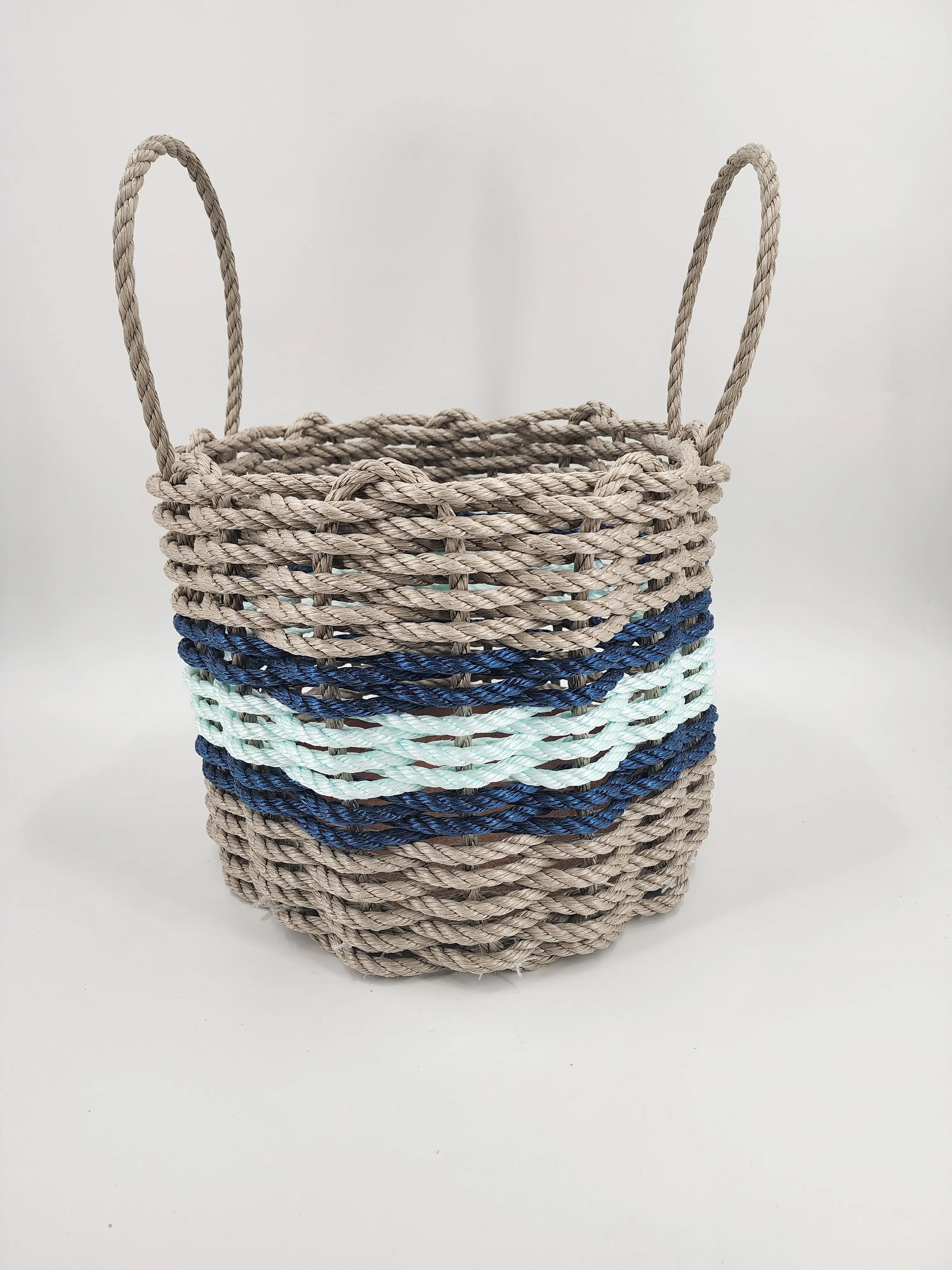 Handmade storage basket woven from Maine lobster rope in tan and seafoam with accent color