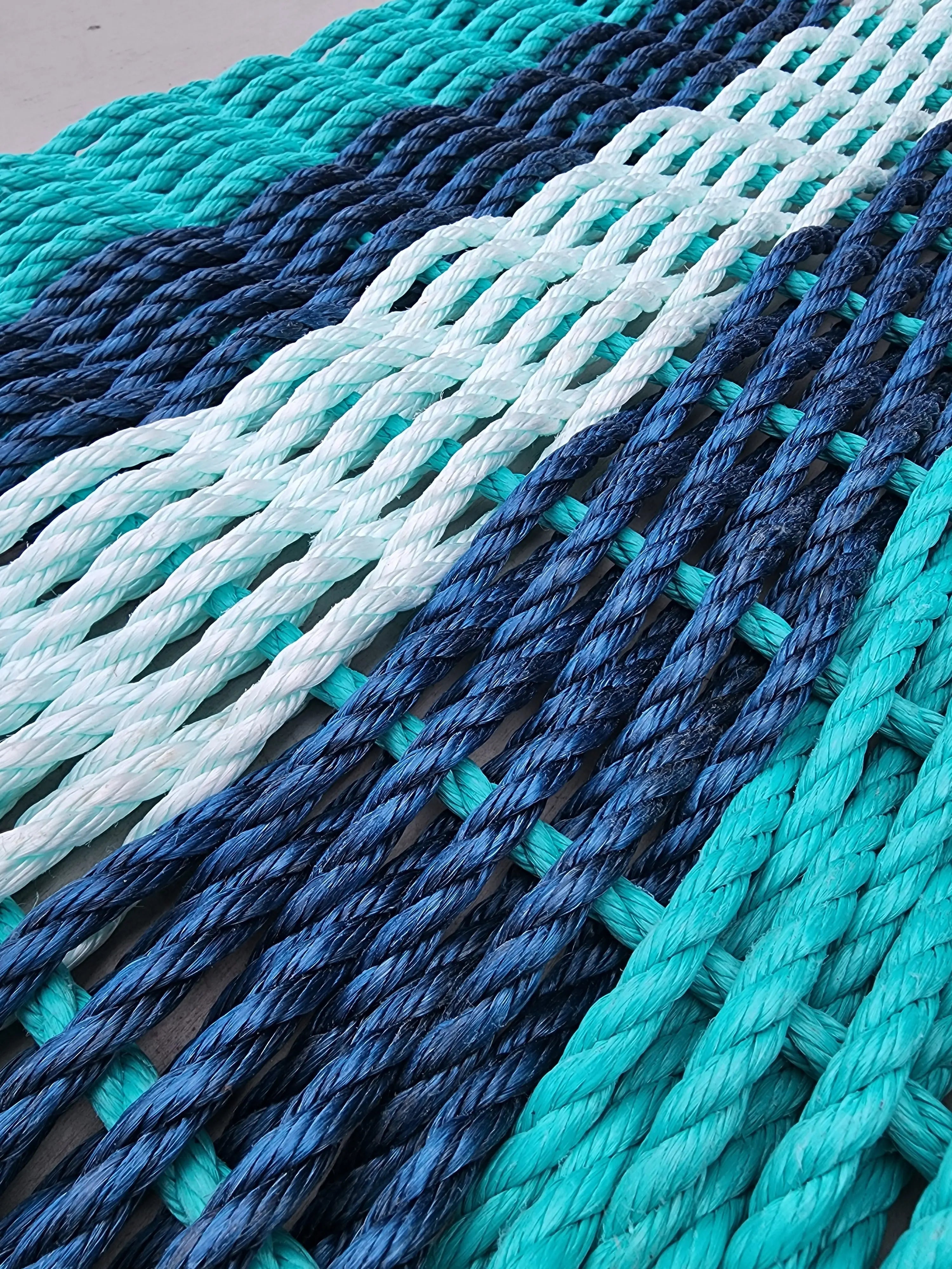 Handmade 5 Stripe Lobster Rope Mat in teal, navy blue, and seafoam colors