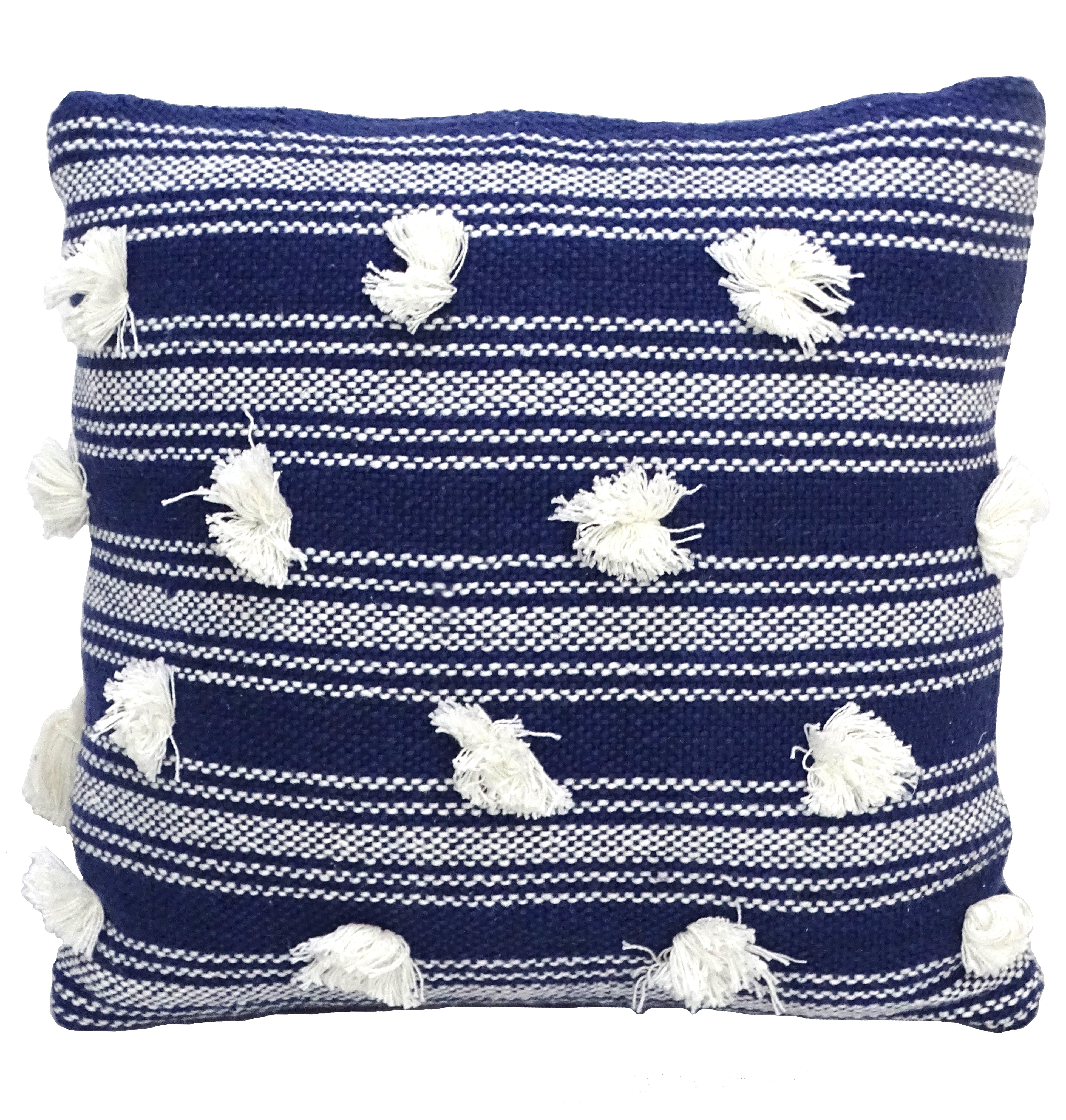 Blue 20 by 20 inch decorative throw pillow with pom pom trim on sofa