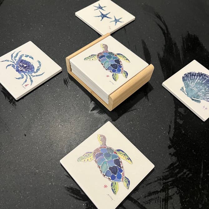 Sea Turtle Coaster set with detailed sea turtle design on a wood caddy holder, styled on a coastal-themed table