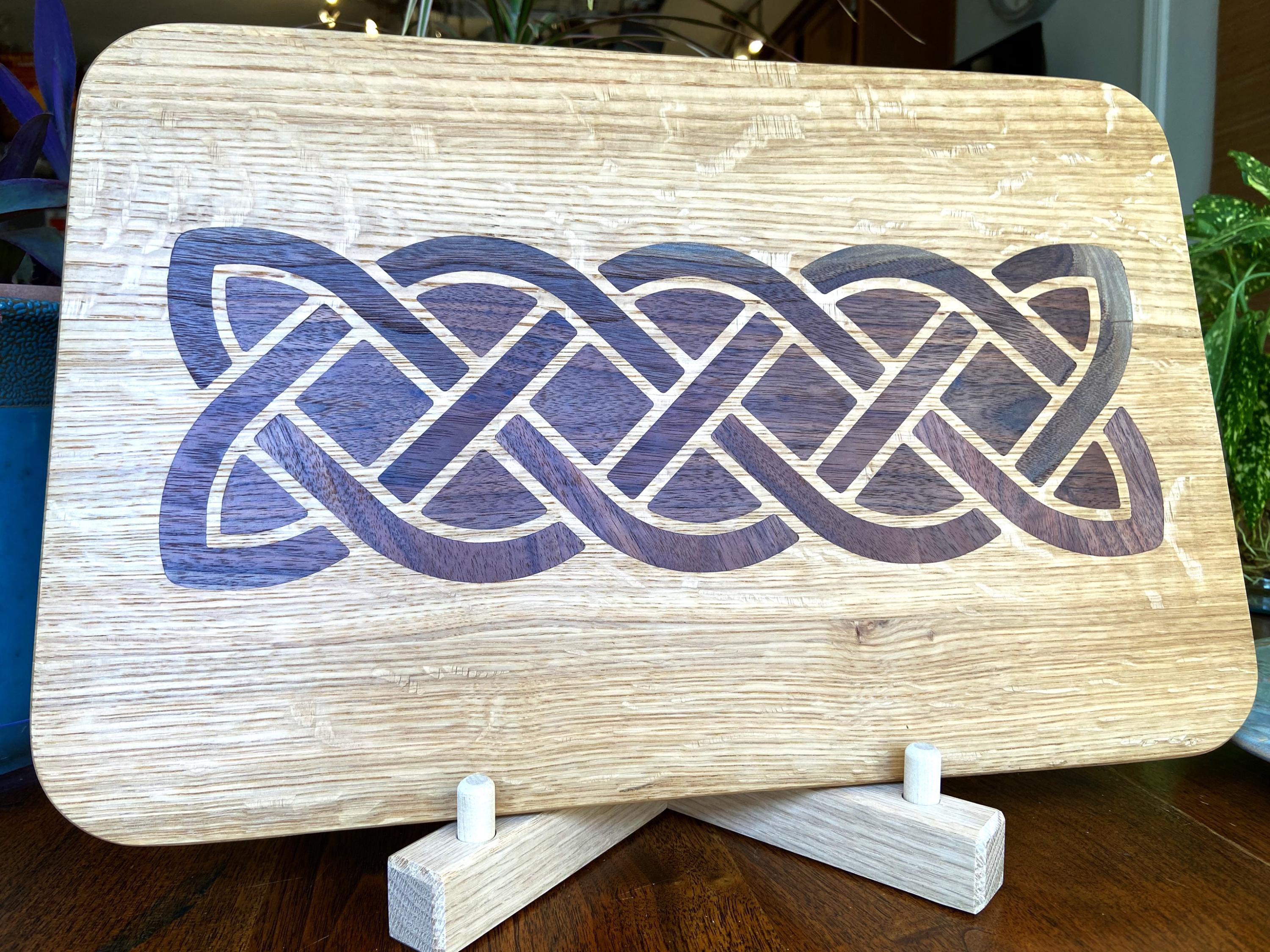 White Oak charcuterie board featuring a complex Celtic knot inlay made of Peruvian Walnut