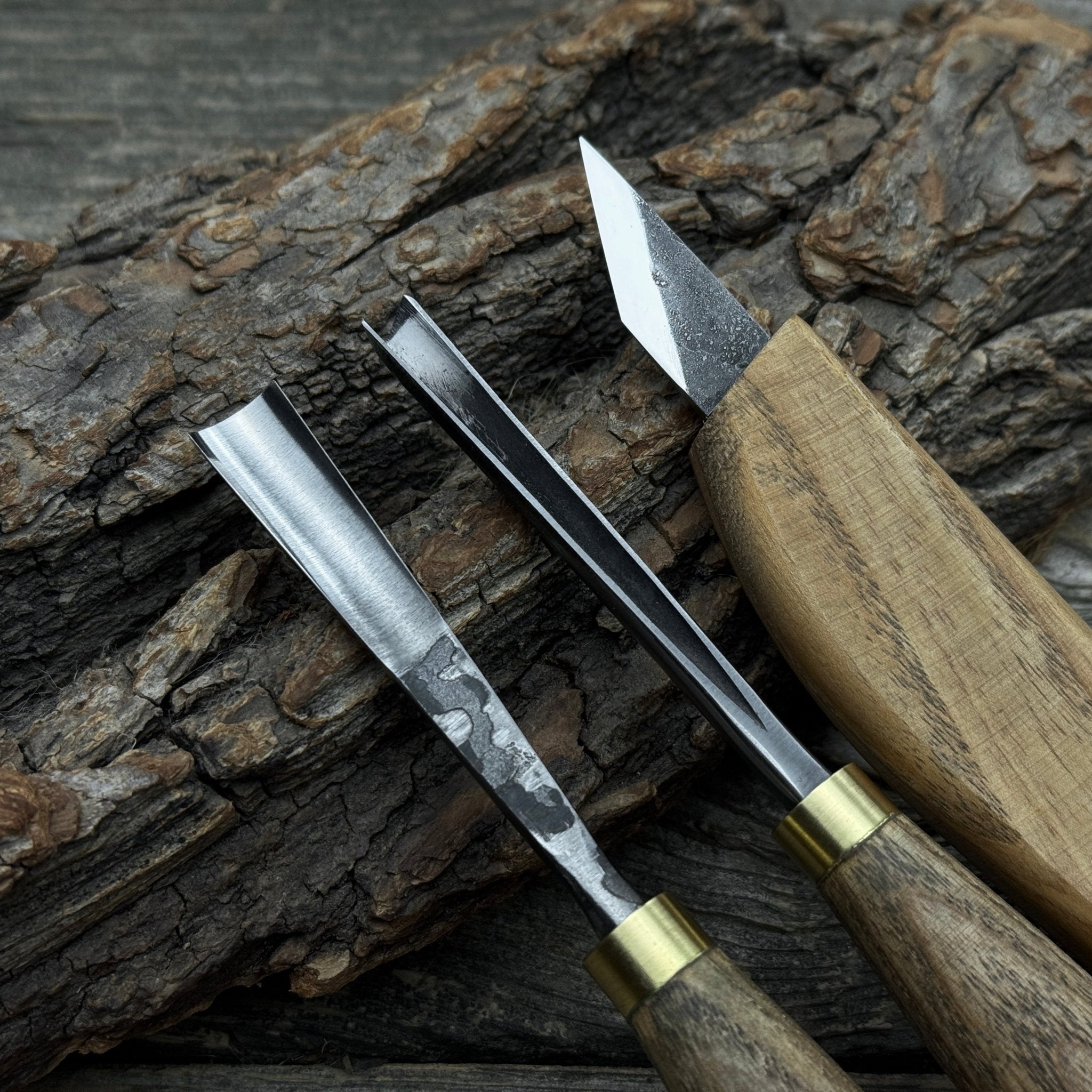 3-piece wood carving tool set with whittling knife, carving gouge, and V-parting chisel on a wooden surface