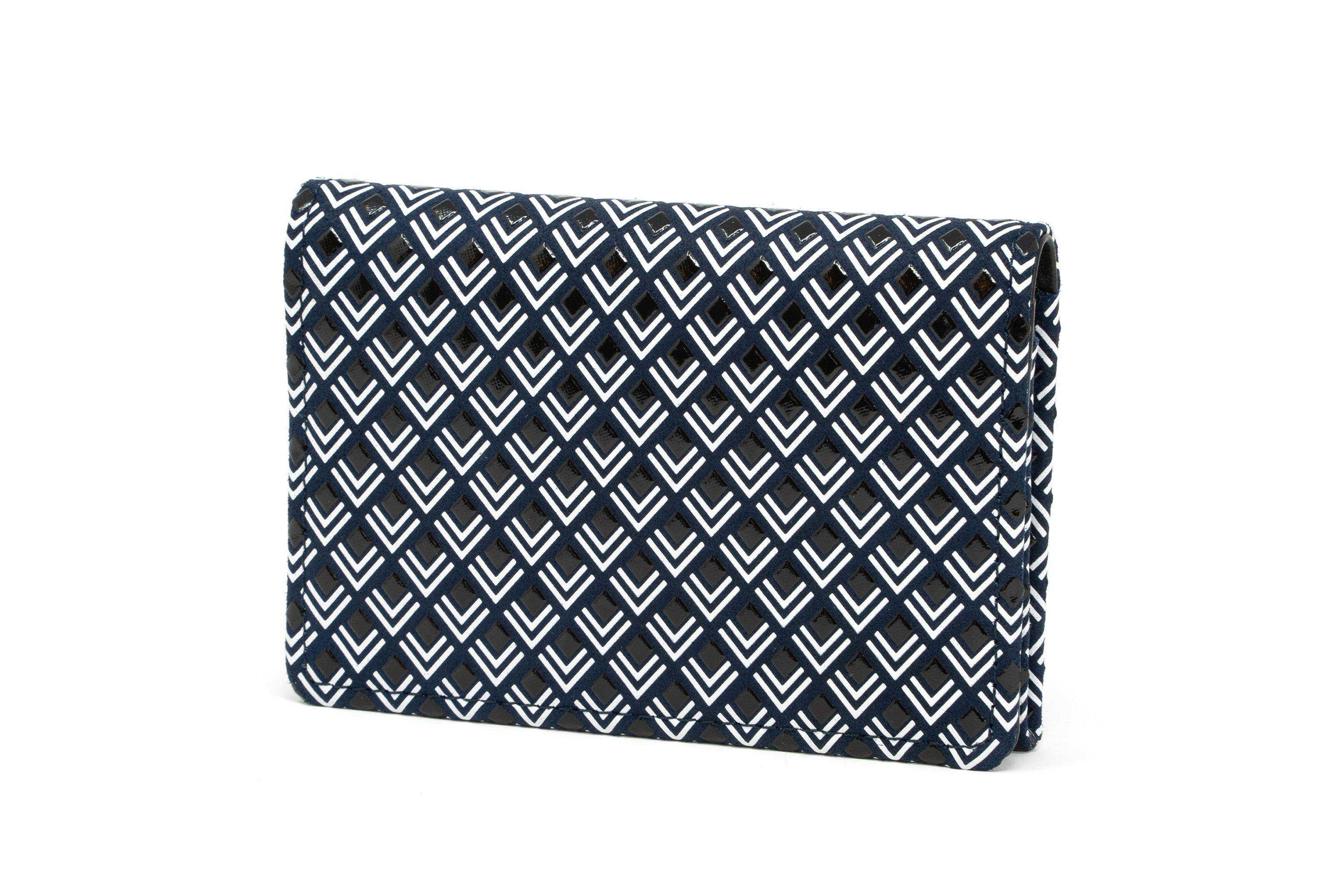 Black and white leather business card case laid on white surface, shown closed and open with cards inside