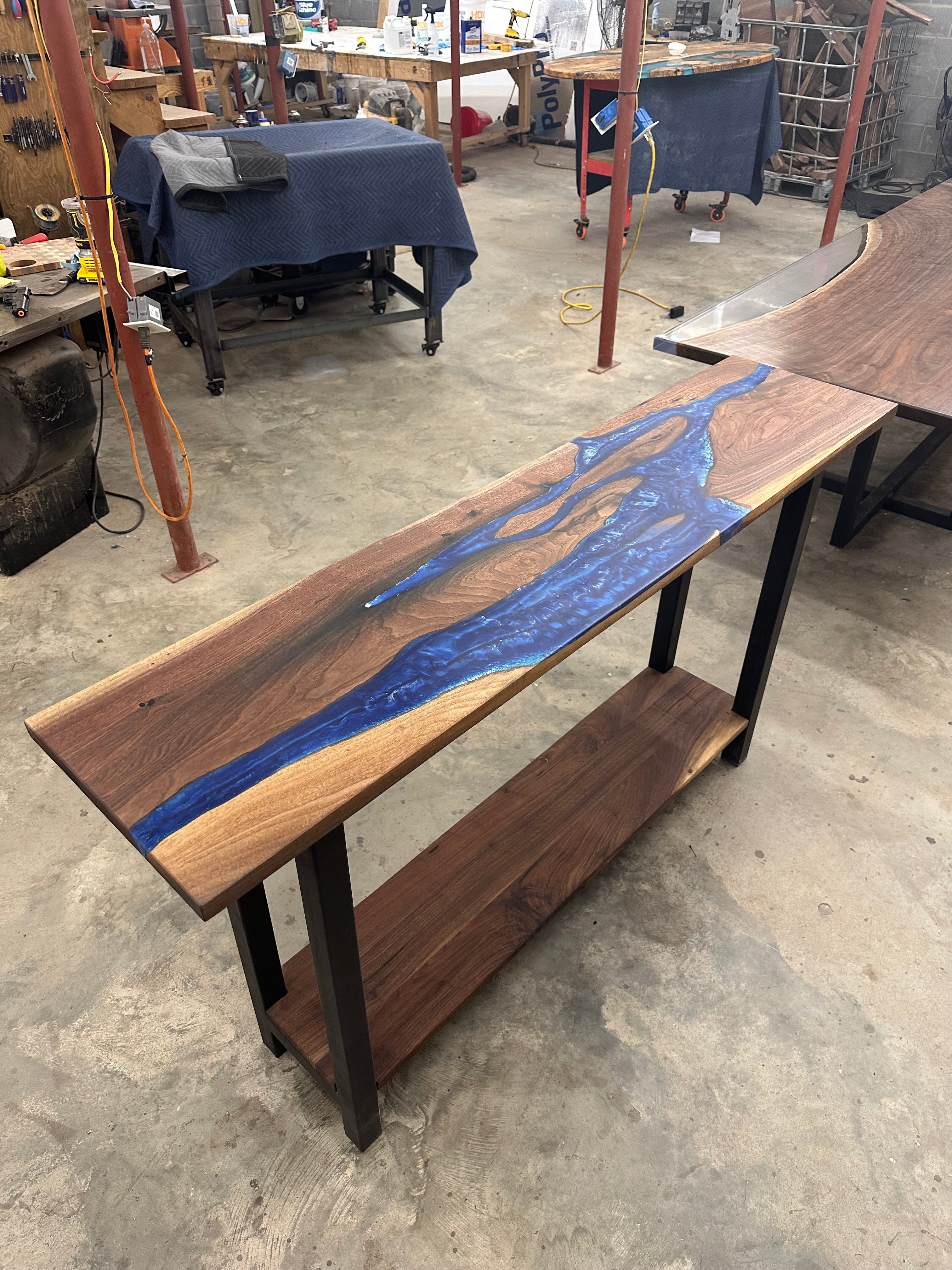 Walnut river console table made with black walnut slabs and blue ocean epoxy