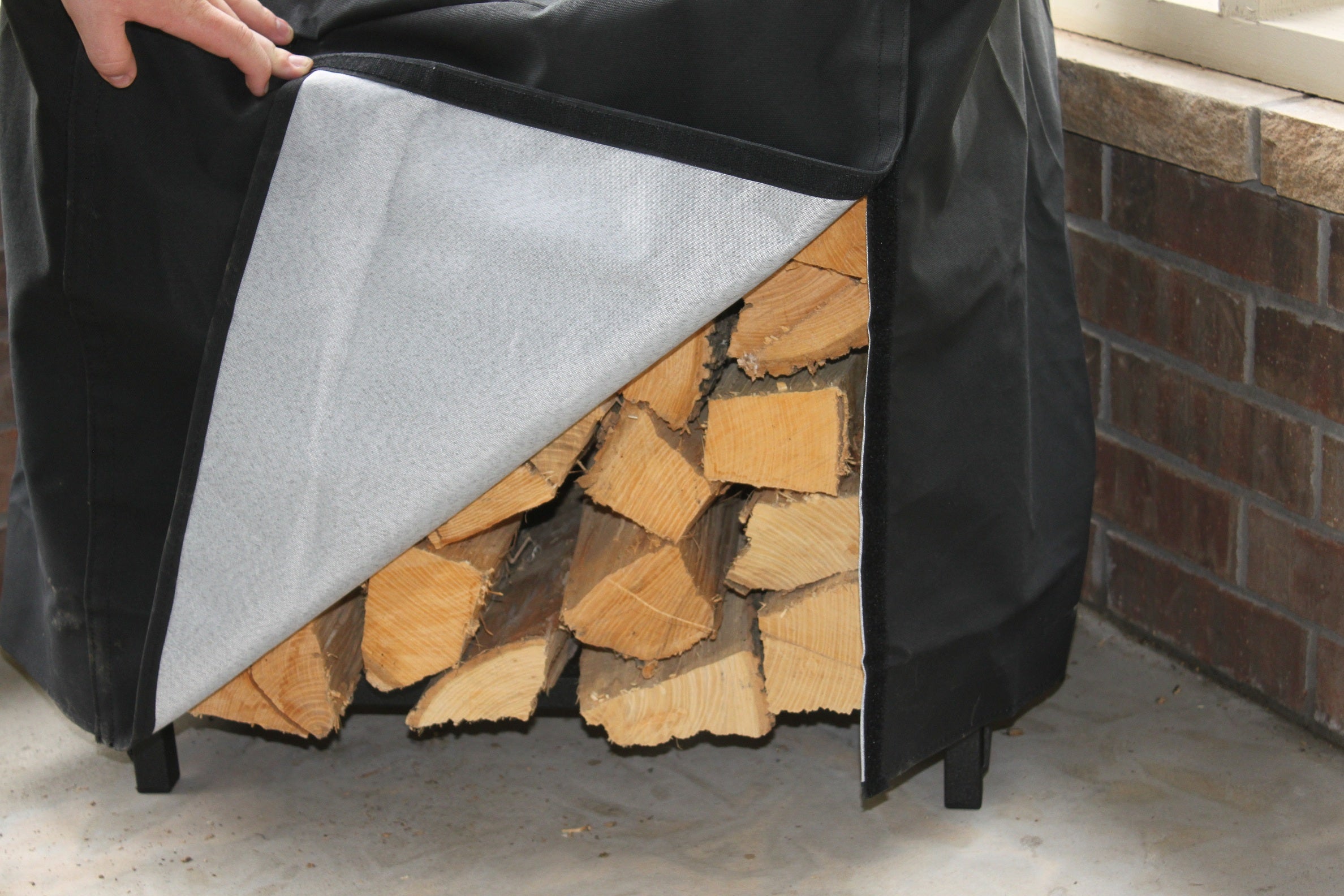 Woodhaven 2 ft Steel Firewood Rack in black with optional cover and support bases