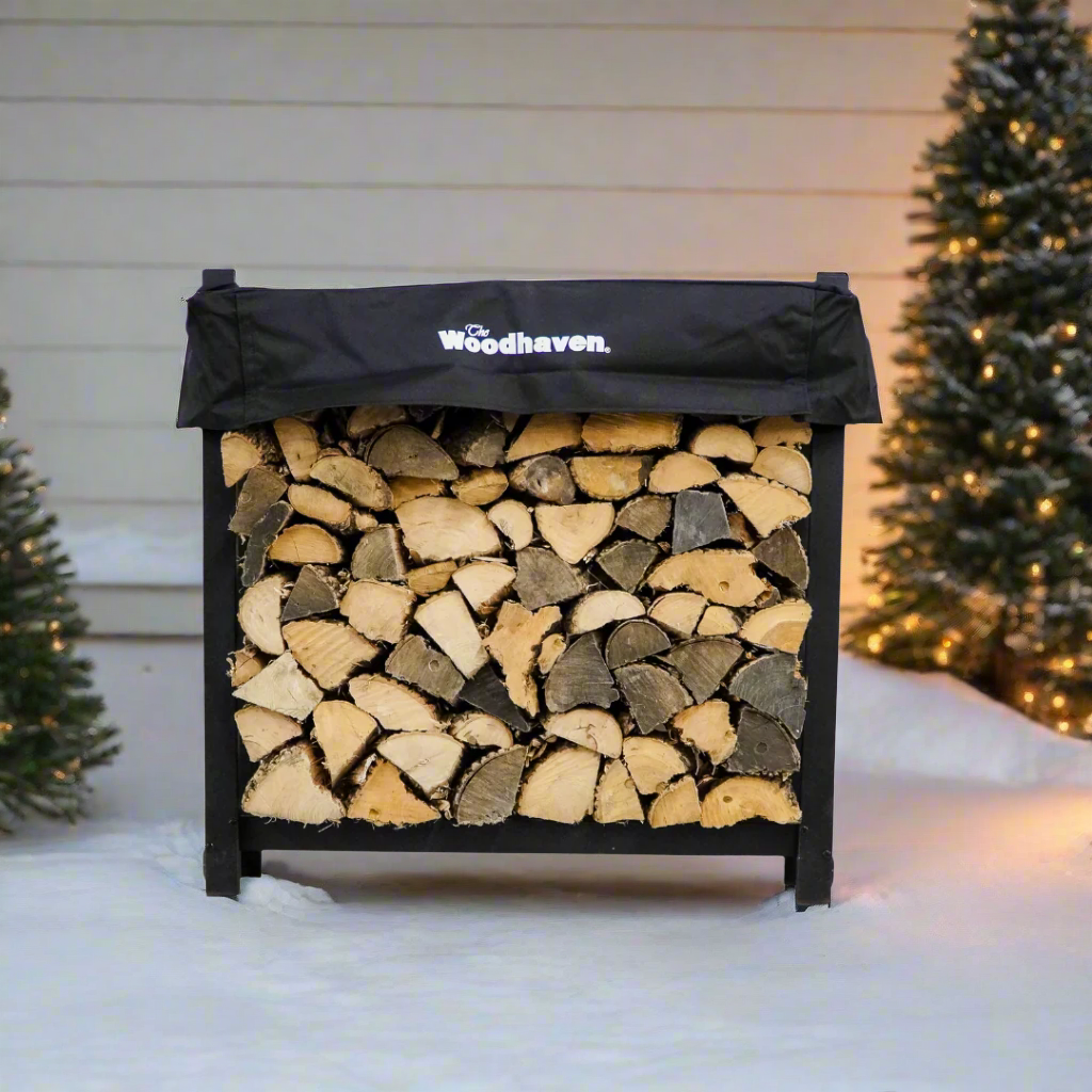 Woodhaven 3 ft Firewood Rack with seasoning cover in black finish holding stacked firewood