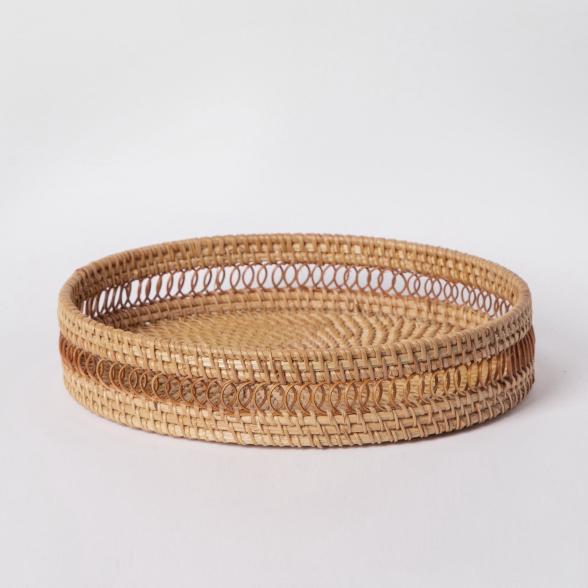 Round white woven rattan tray displayed on a table