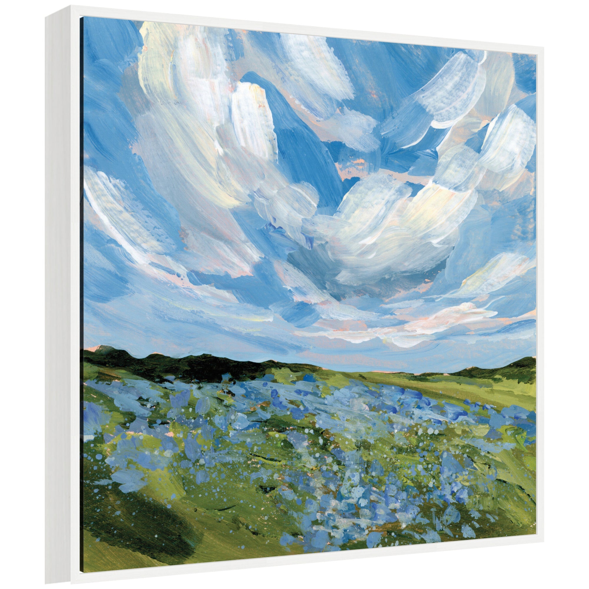 Framed canvas wall art titled Texas Bluebonnets by Emily Kenney depicting a green field with blue wildflowers under a sky of swirling clouds in a white Sylvie frame.