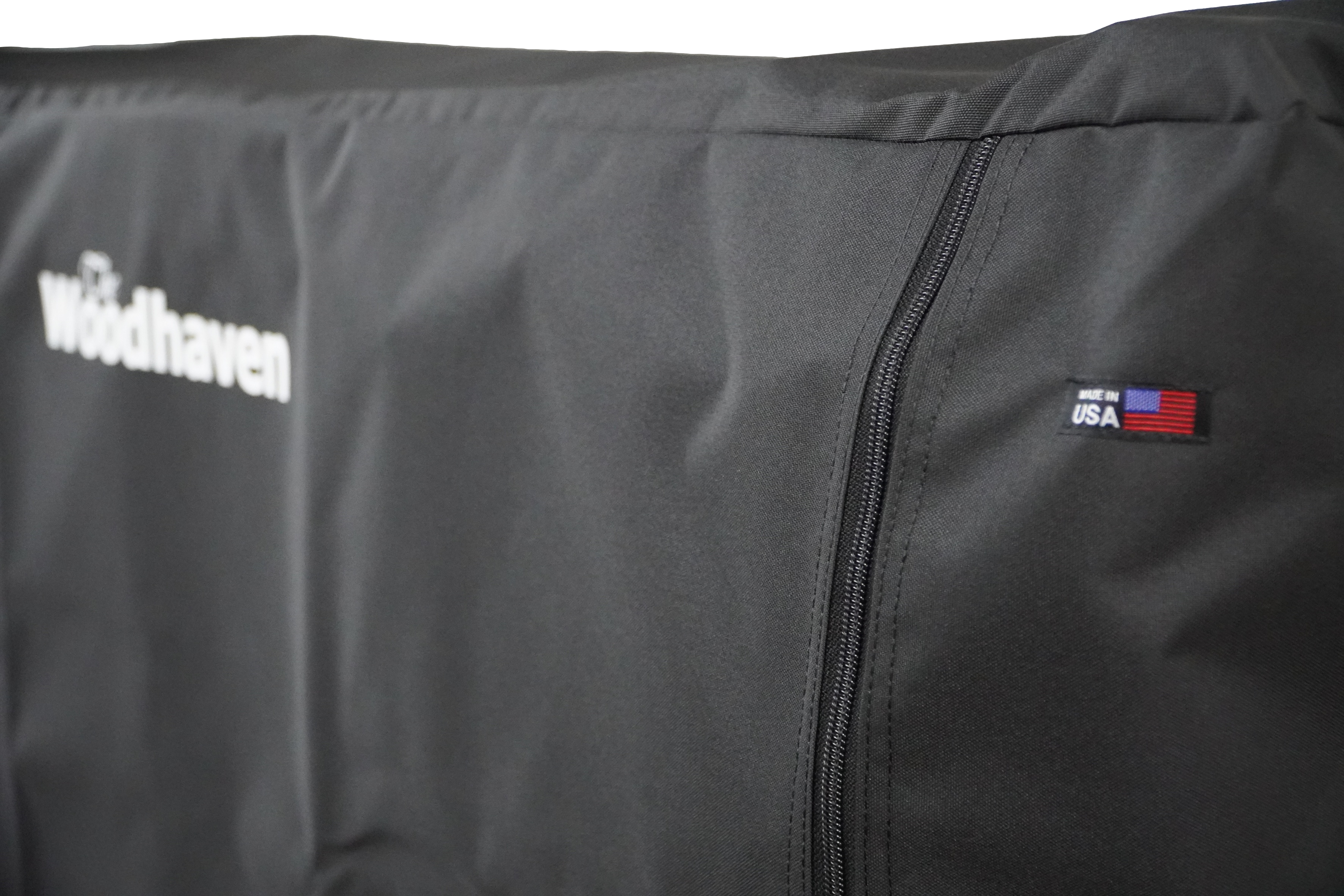 Woodhaven Full Firewood Rack Cover with zipper closure protecting stacked firewood outdoors