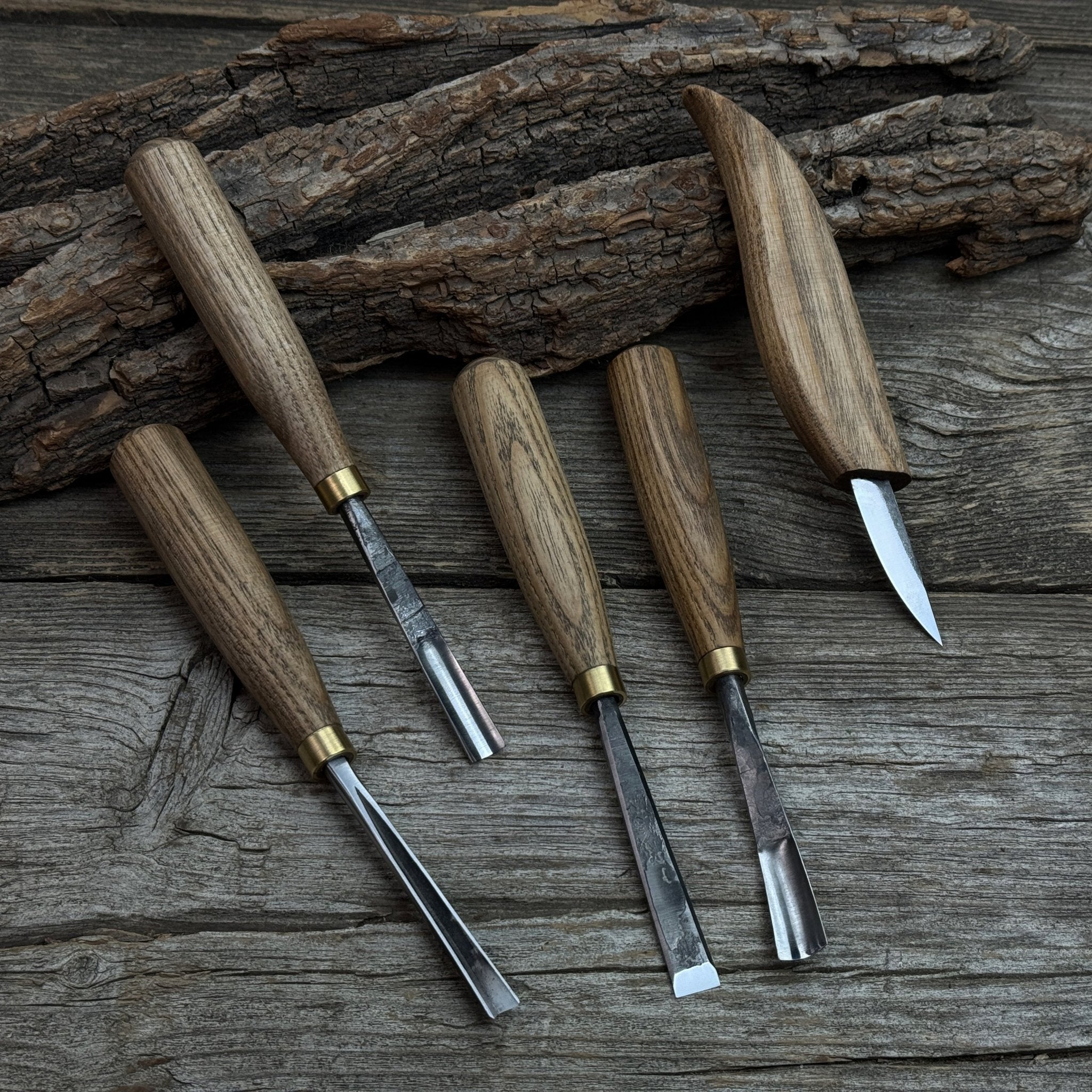 5-piece wood carving tool set with whittling knife and four chisels on wooden surface