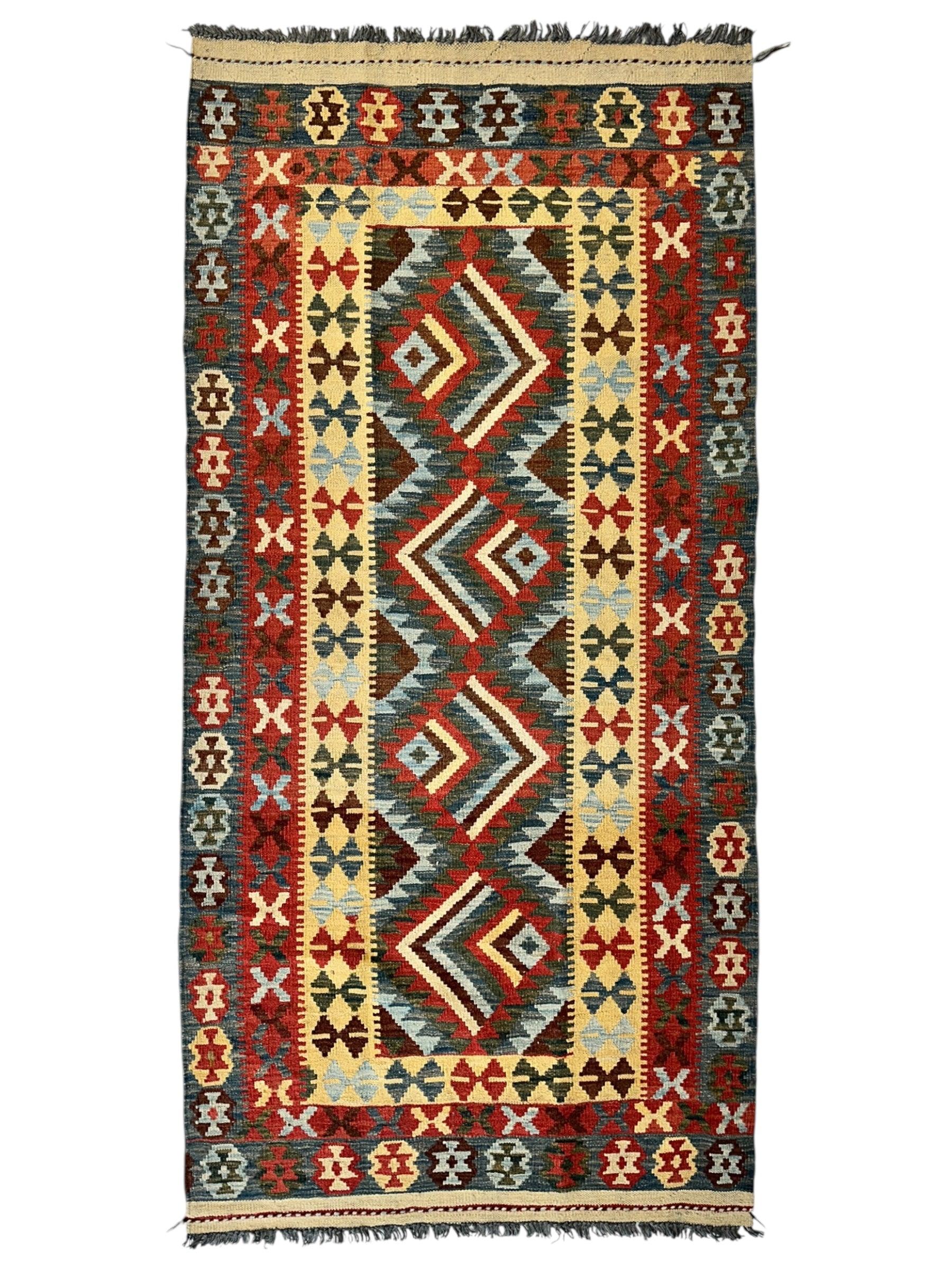 Afghani Maimana Kilim Wide Runner Rug with geometric patterns in neutral and warm tones on a floor