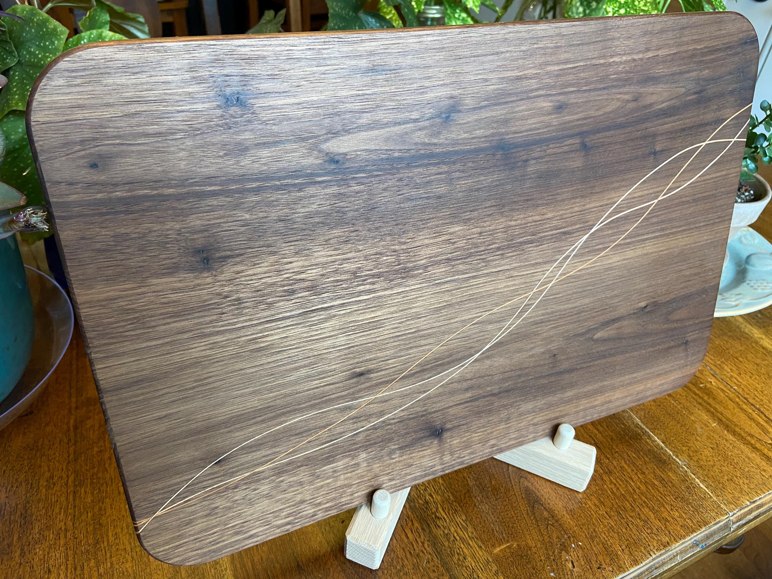 Handcrafted walnut charcuterie board with cherry and maple decorative banding