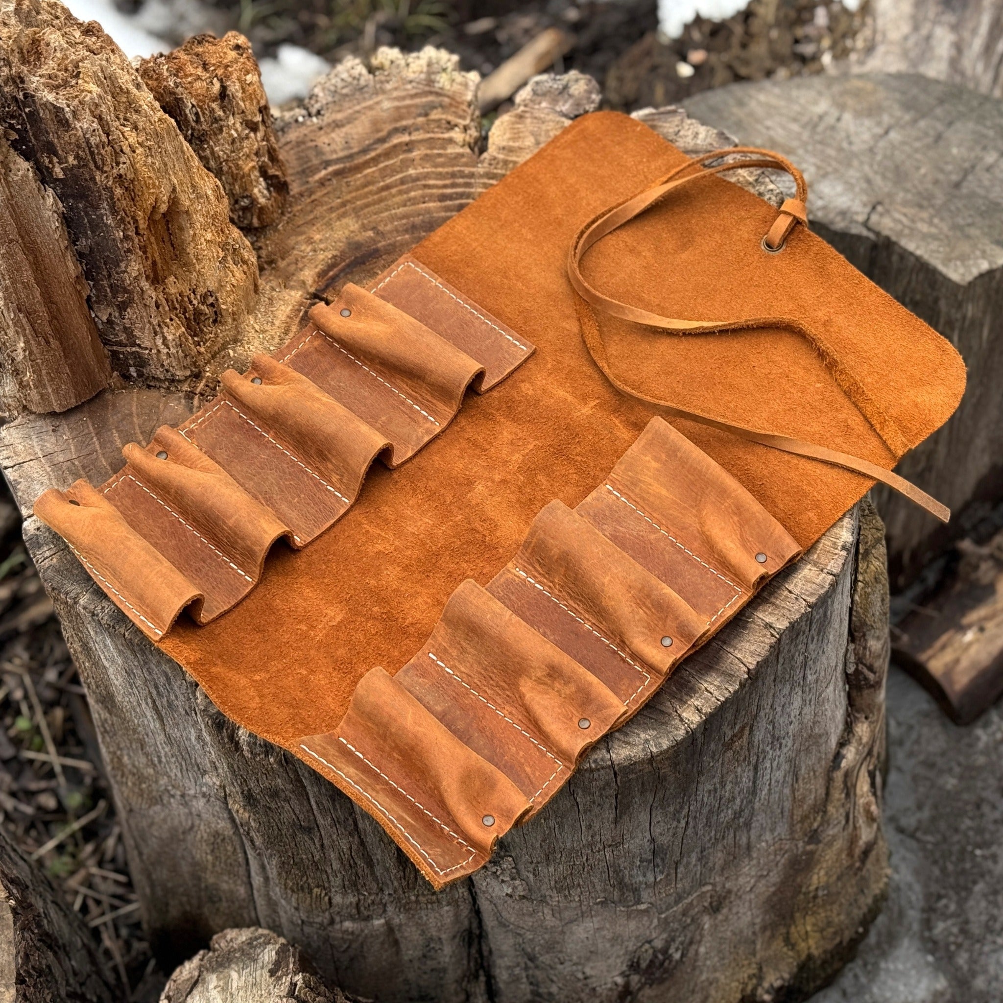 Handmade 8 pocket leather tool roll by Sharky Forged Steel Tools, open with tools inside
