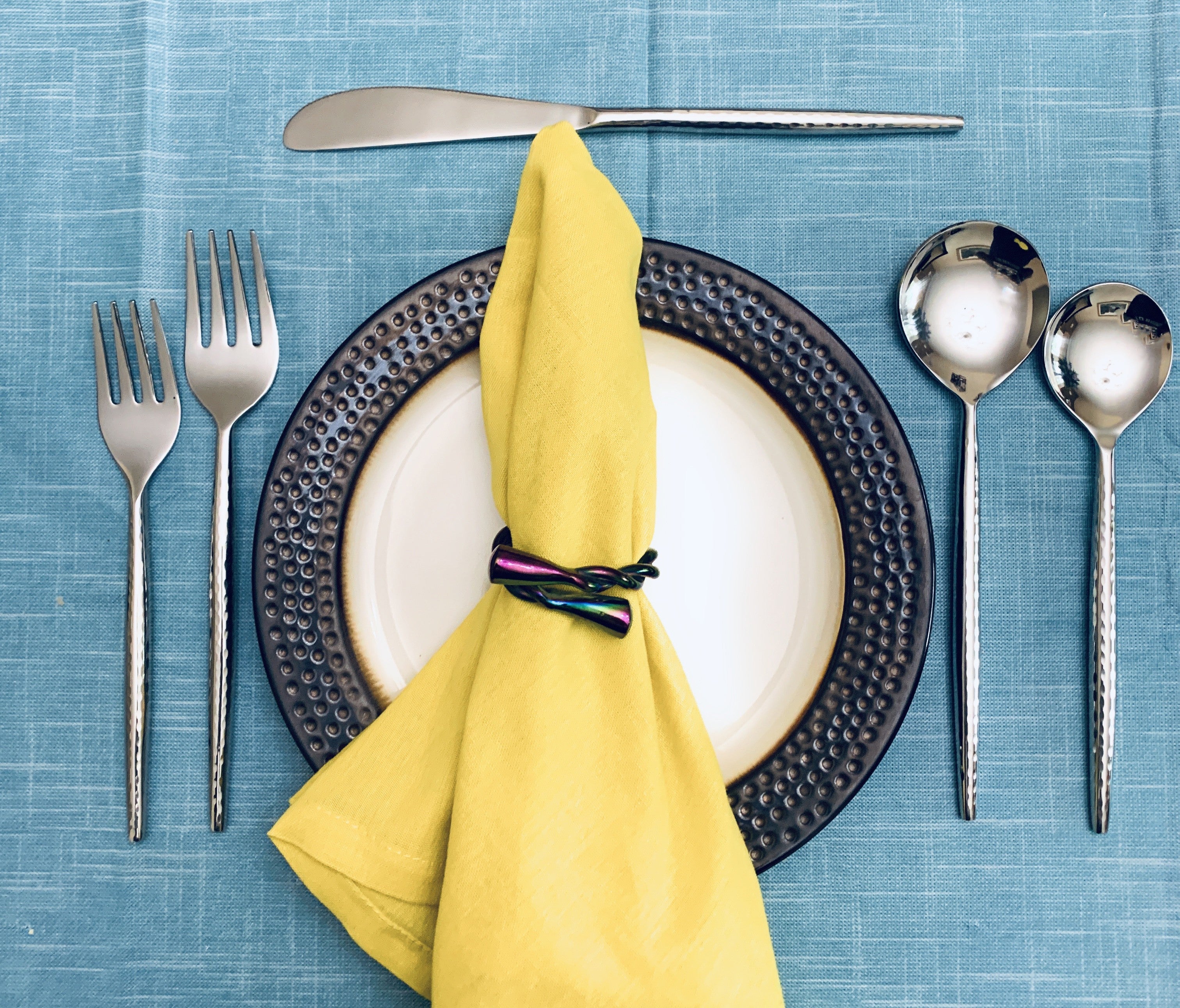 Hammered Silver Flatware Stainless Steel Set of 20 arranged on a table