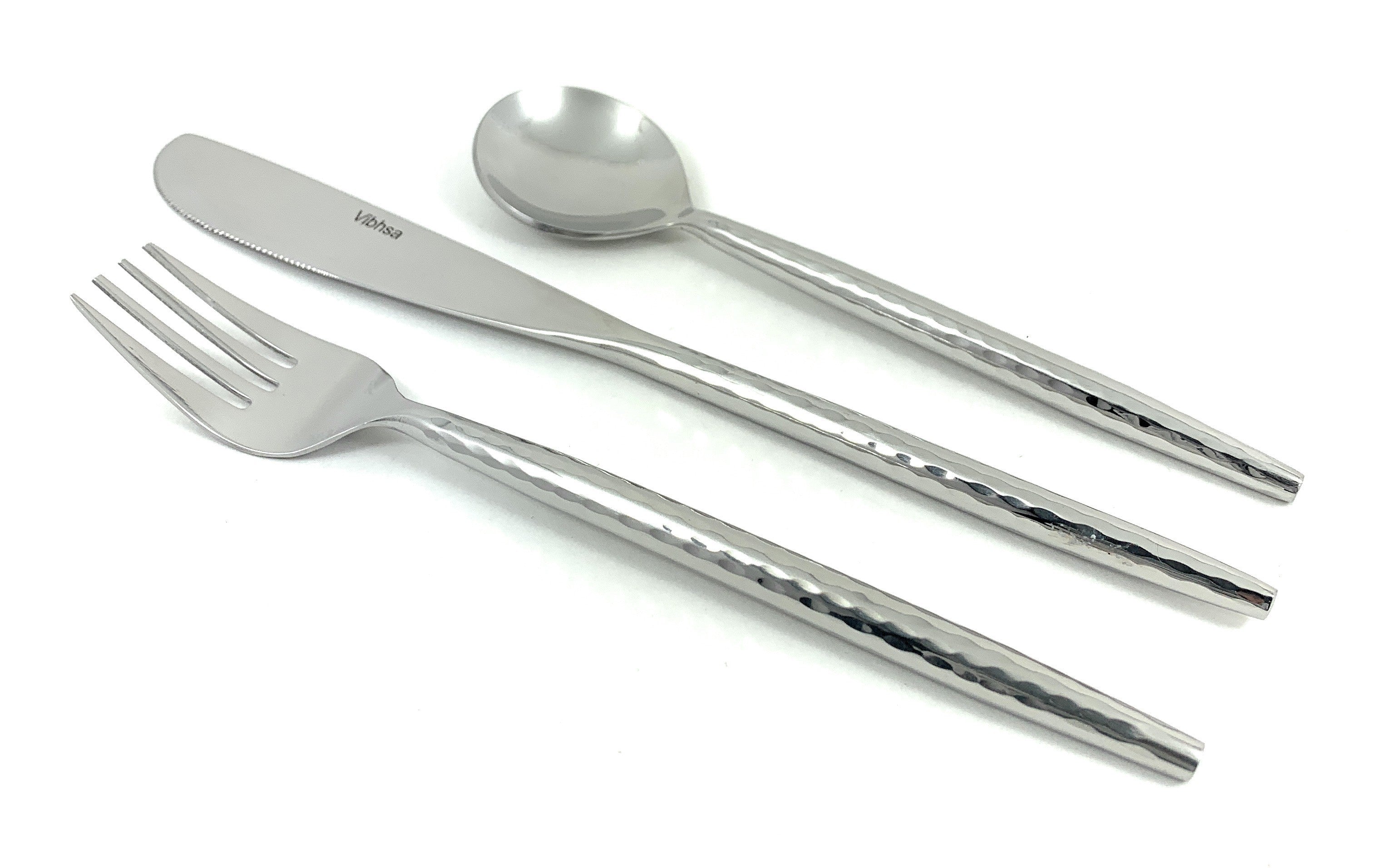 Hammered Stainless Steel Flatware 18-Piece Set with knives, forks, and spoons arranged on a tabletop
