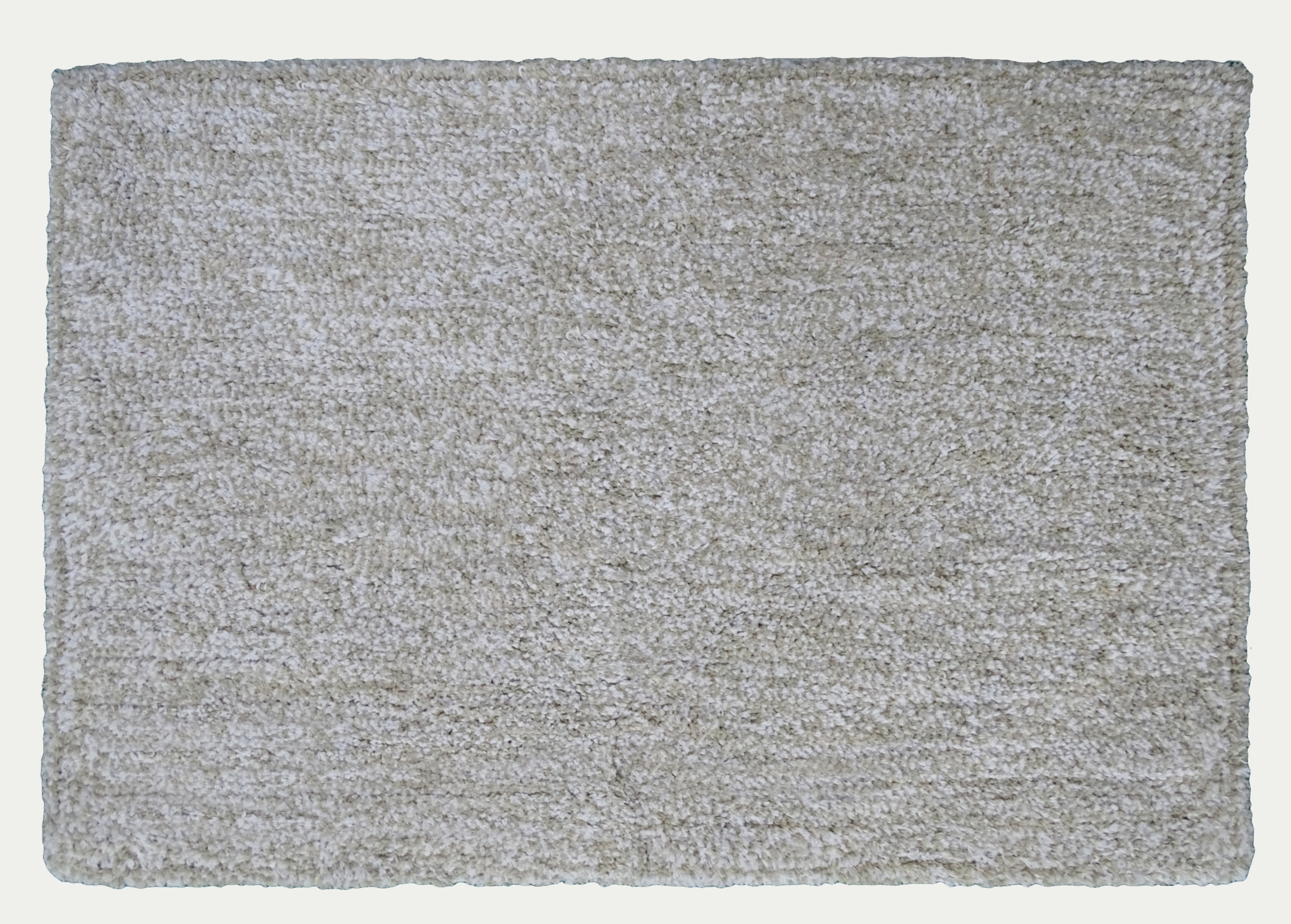 Ivory and white geometric patterned bath rug by CHICOS HOME on bathroom floor