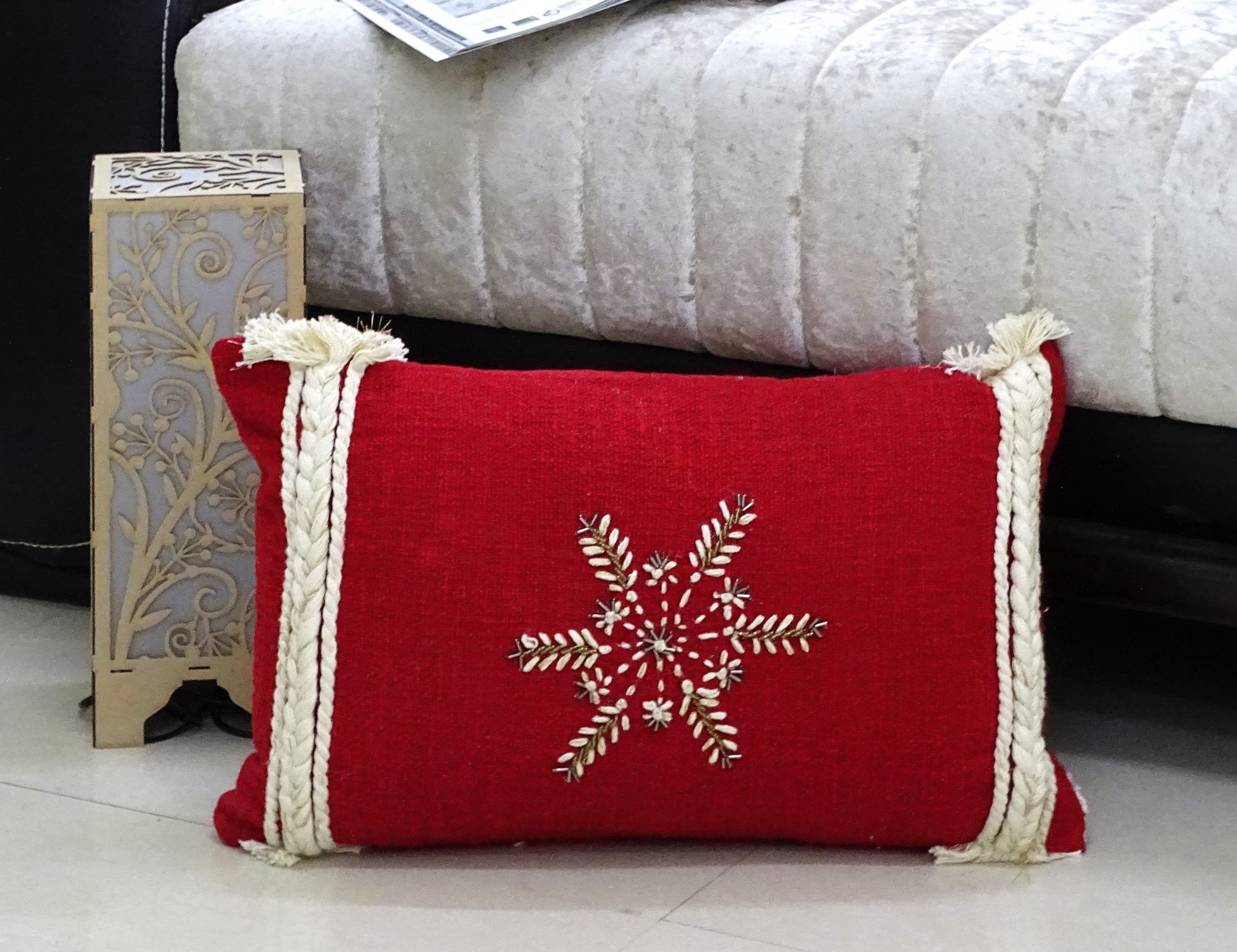 Christmas Throw Pillow 14x24" with embroidered snowflake design and pom pom details on a sofa