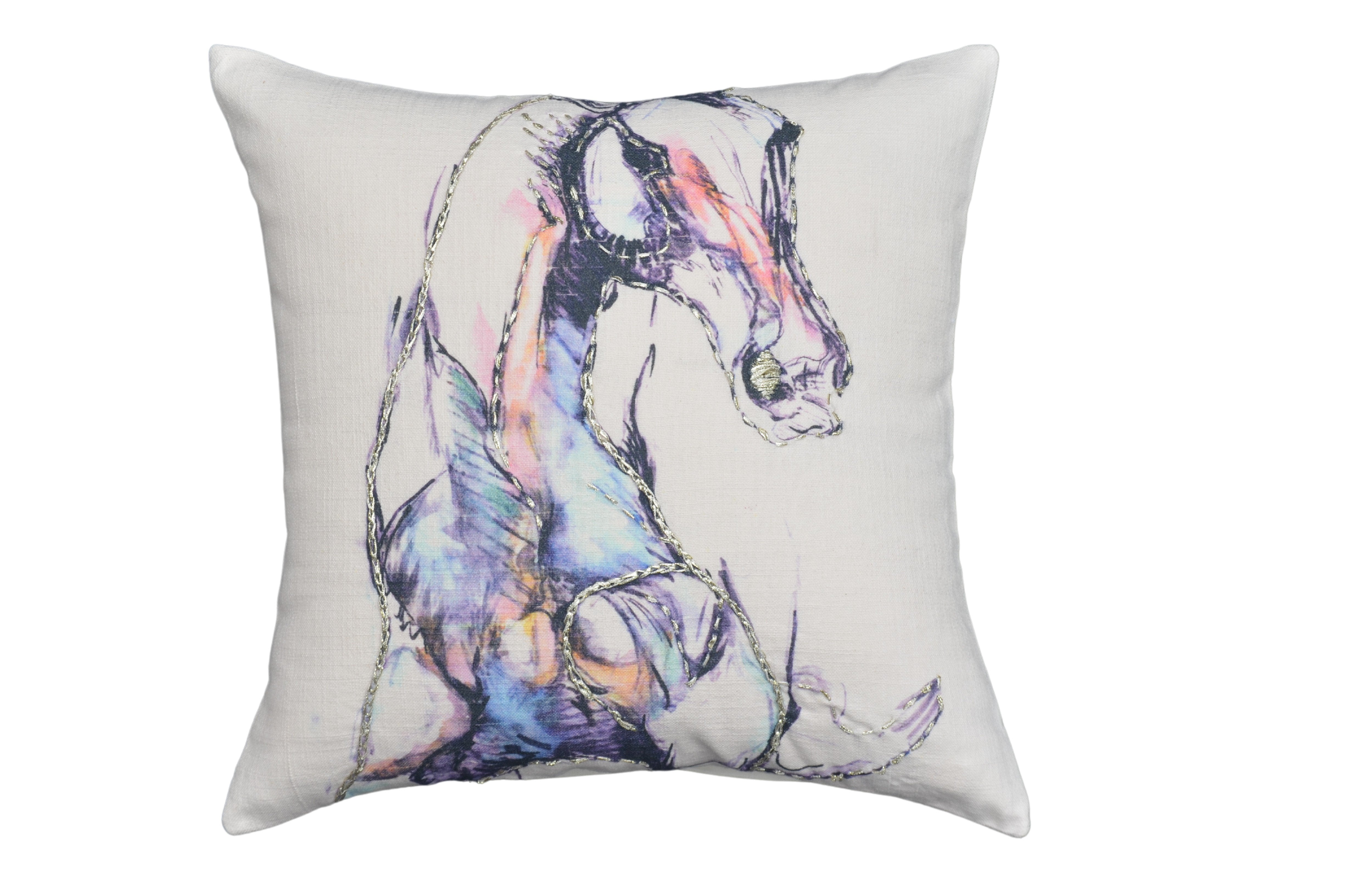 White decorative pillow 18x18 with black embroidered animal print, pom-poms, and tassels on a blue upholstered chair