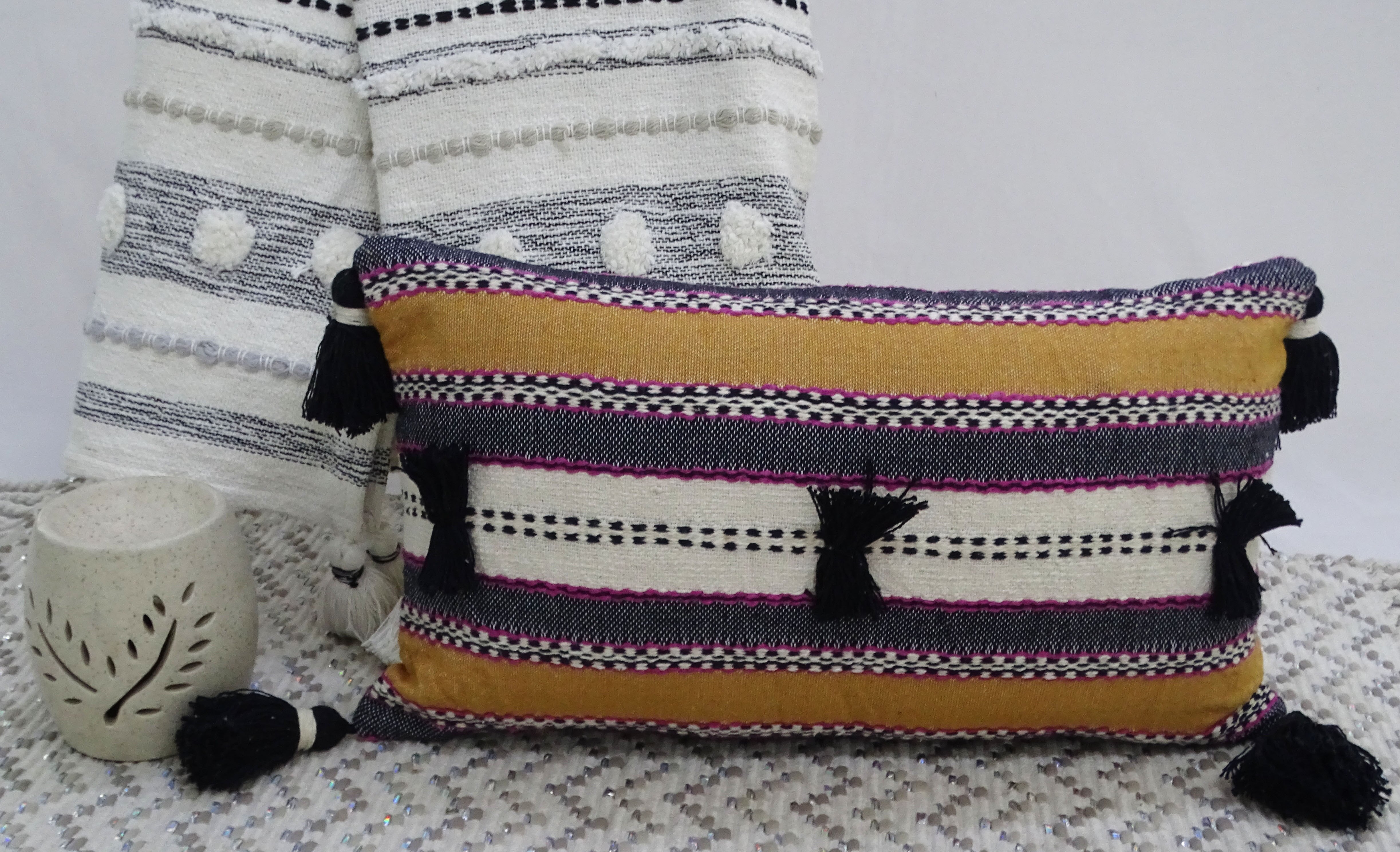 Handwoven 14x24 throw pillow with colorful front and corner tassels