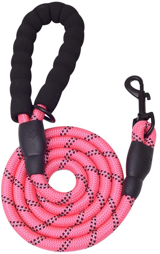 Pink dog leash with padded handle and metal clasp on wooden floor