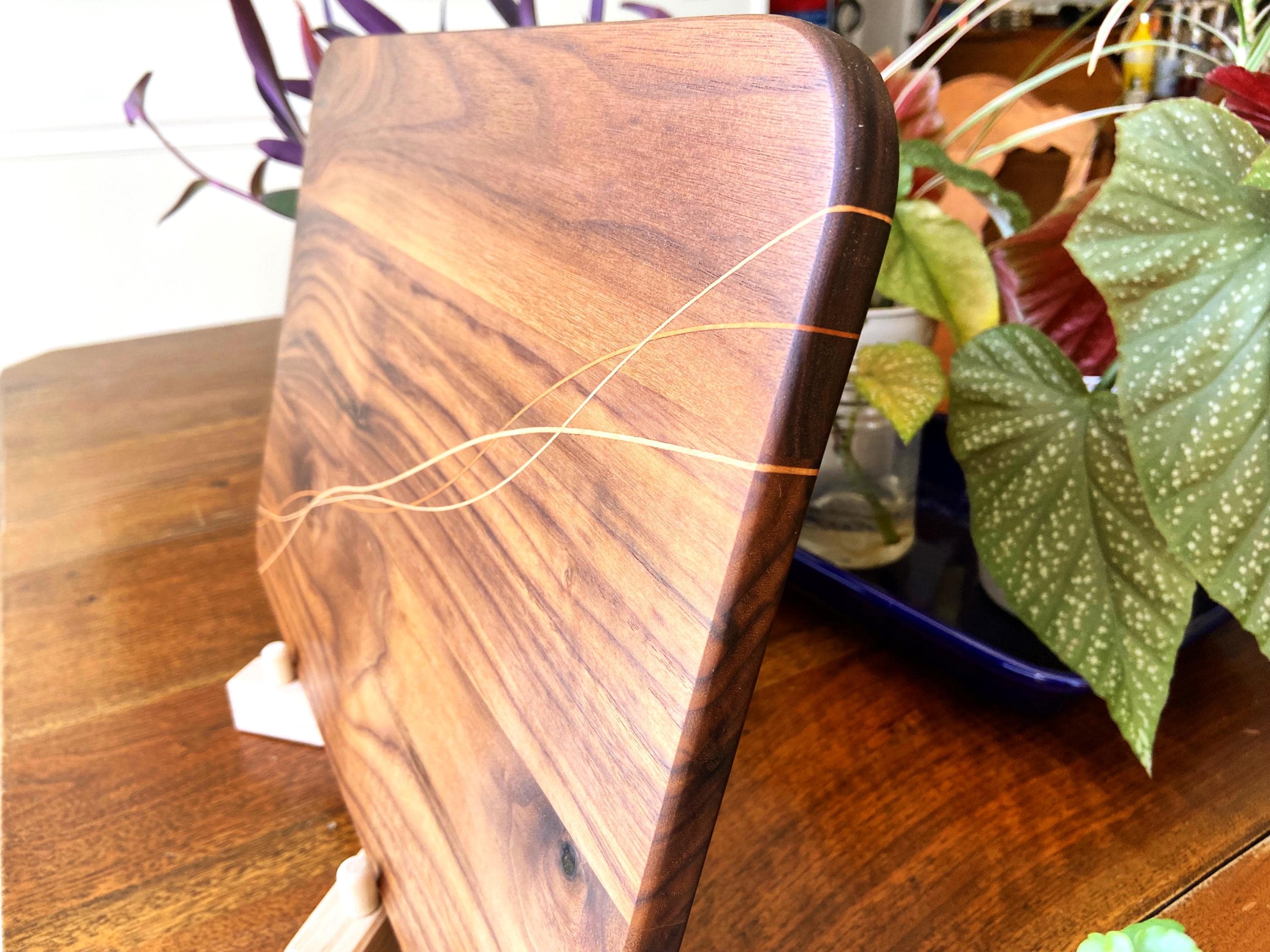Walnut charcuterie board with Cherry and Maple decorative banding, handcrafted by Fitzgerald Custom Woodcraft