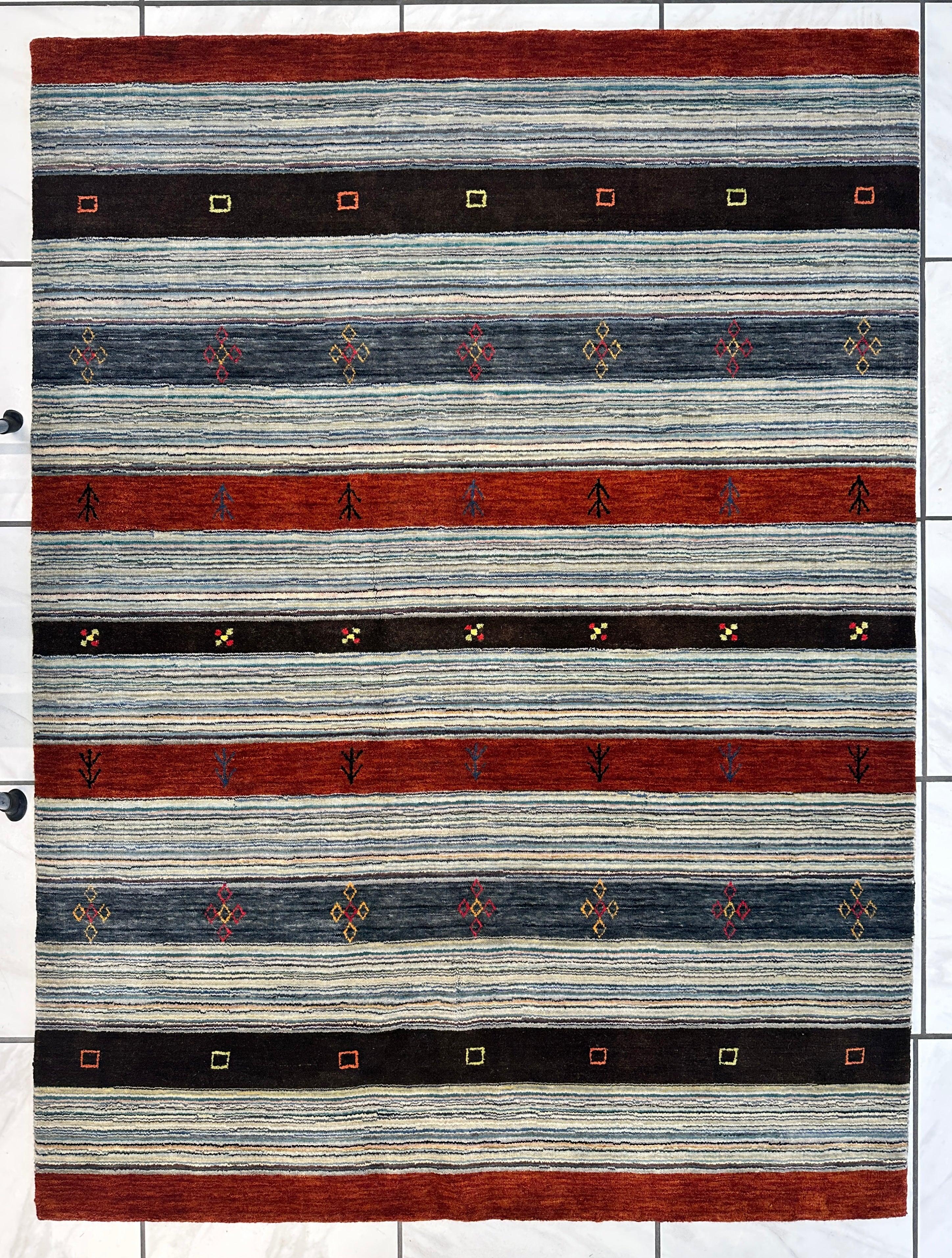 Hand-knotted Indo-Gabbeh wool and bamboo rug with horizontal stripes and vibrant motifs in reds, blues, and blacks