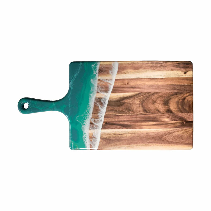 Wooden resin charcuterie board with a green handle and ocean wave design on a white background