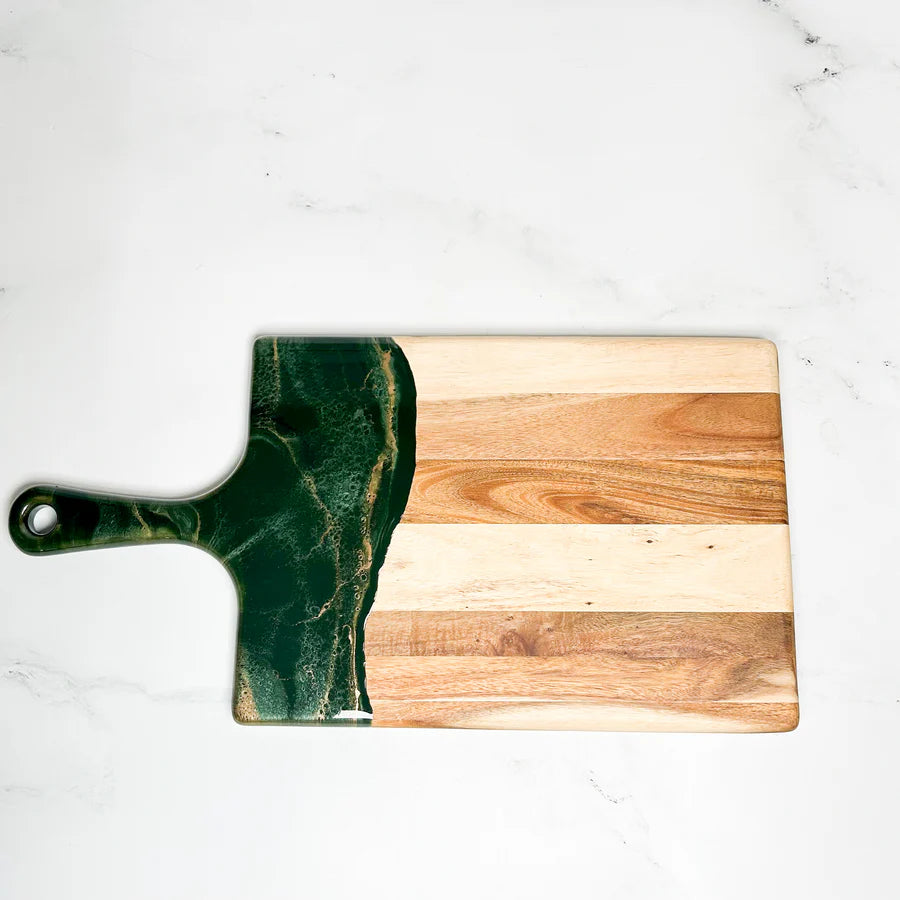 Wooden resin charcuterie board with a green marble handle on a white surface