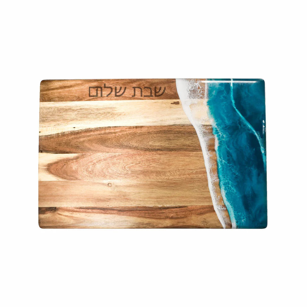 Wooden resin charcuterie board with blue resin design on a white background