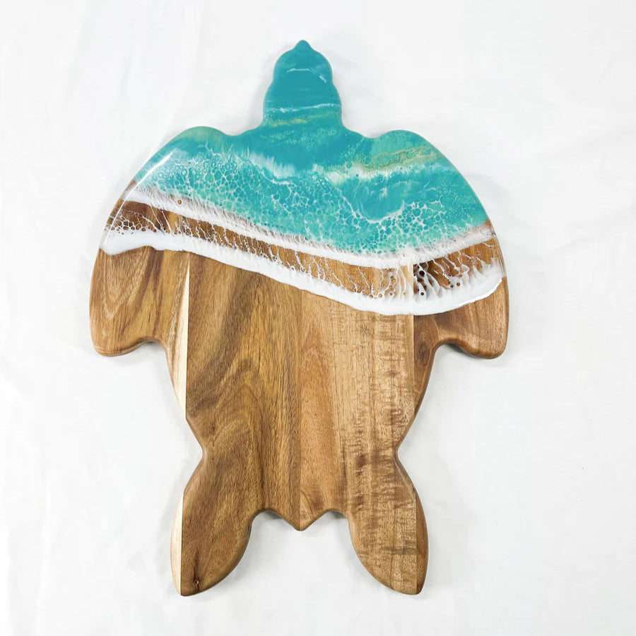Wooden resin charcuterie board with a resin design of a wave on a white background