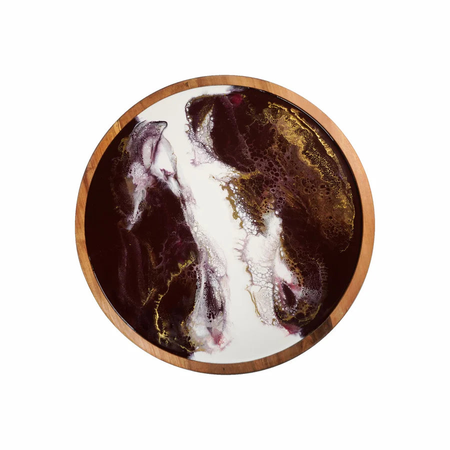 Round resin lazy susan tray with a marbled design on a white background