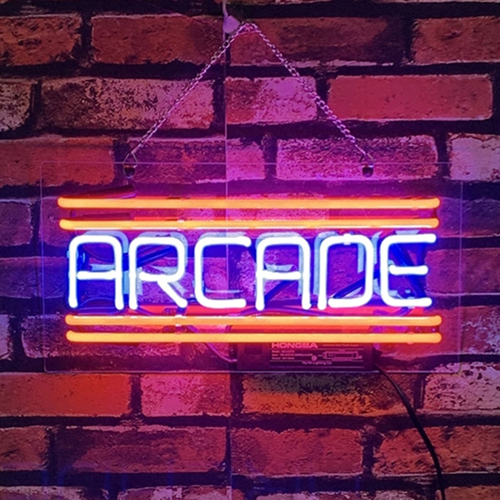 Arcade Neon Signs illuminated hanging on a wall.
