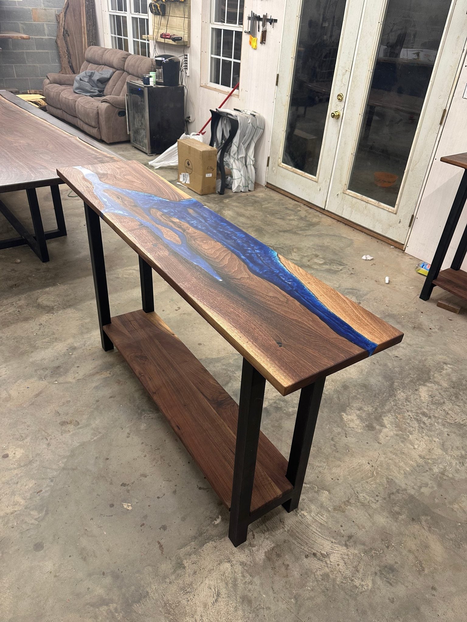 Walnut river console table made with black walnut slabs and blue ocean epoxy