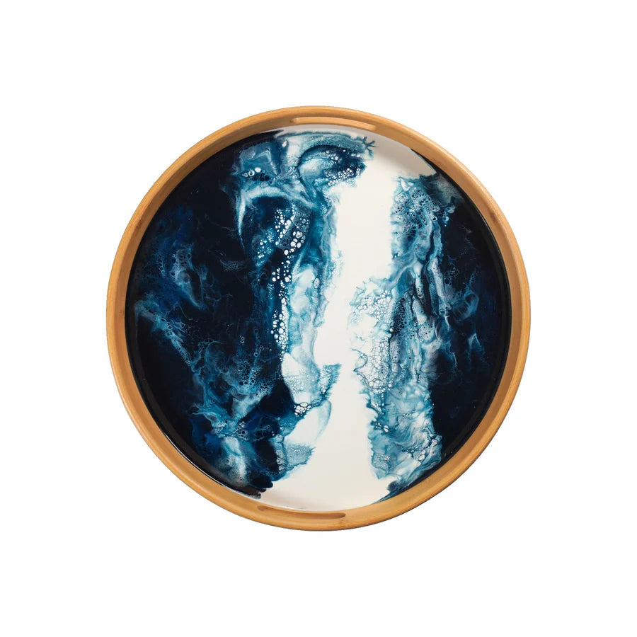 Round resin serving tray with blue and white abstract design on a wooden rim