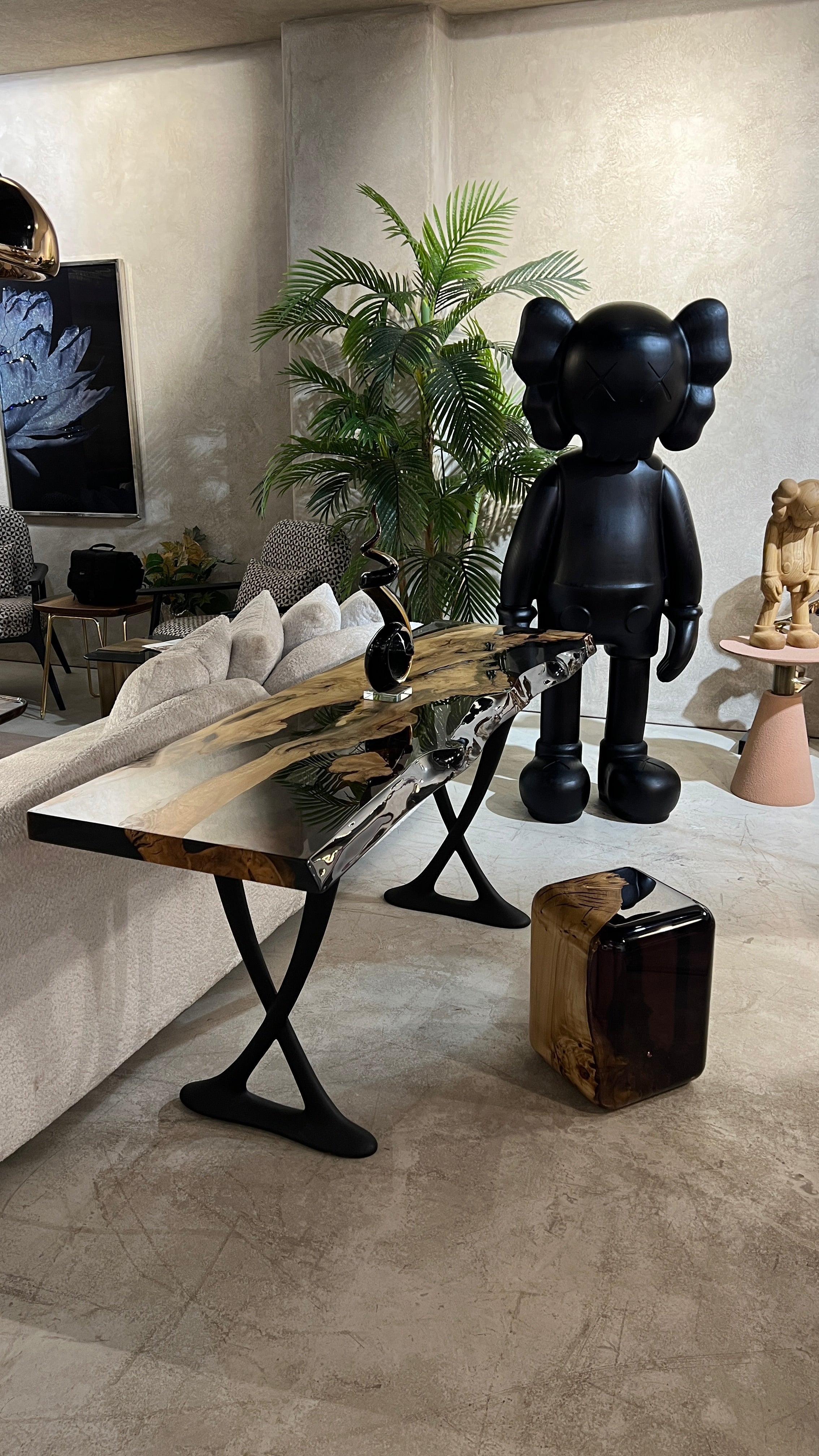 Handcrafted resin live edge console table made of aged linden wood with aluminum legs in a foyer setting