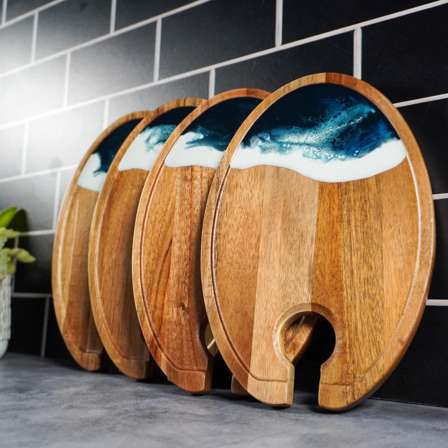 Set of resin Wine & Appetizer Trays with ocean wave design against a tiled wall.