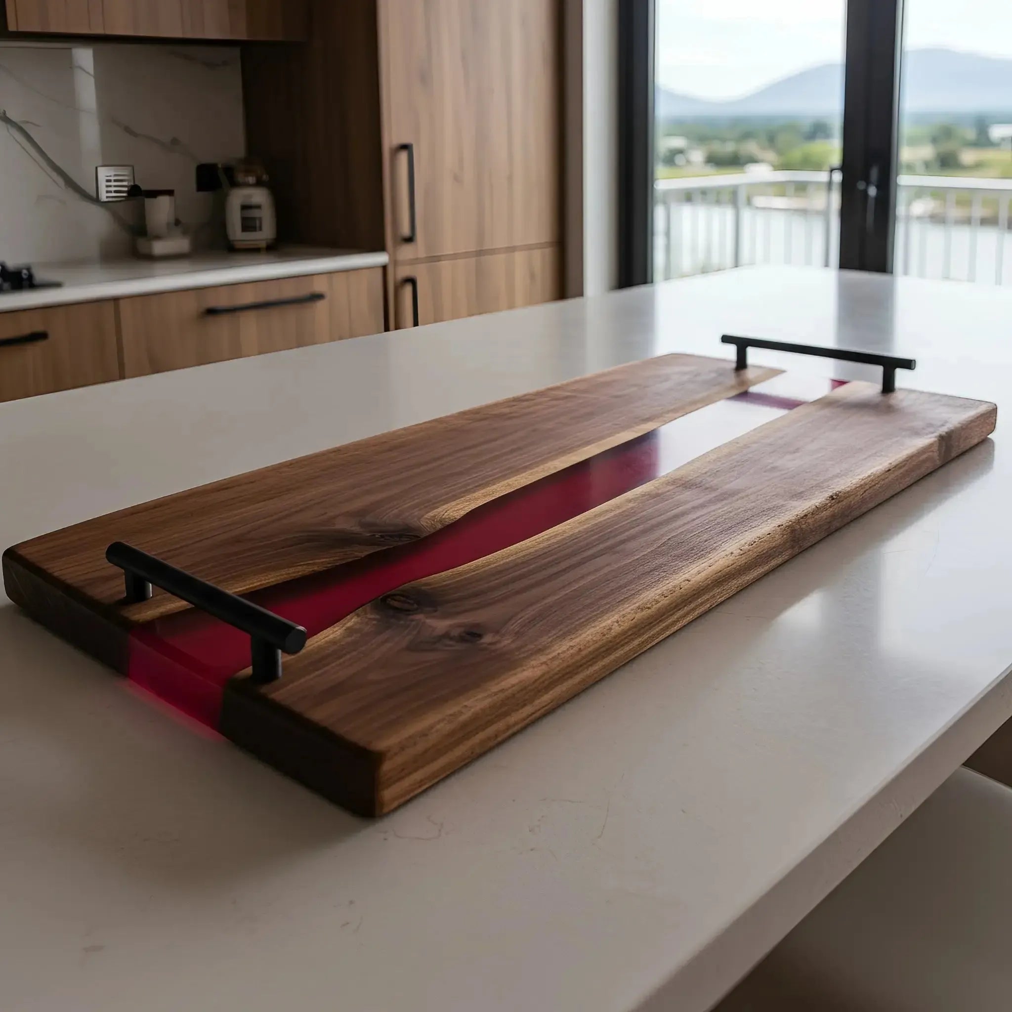 charcuterie board, 18 inches by 9 inches, made from live edge black walnut wood with a deep, merlot-colored epoxy river running through the center. The resin is a rich burgundy tone with a smooth, glassy finish. Matte black handles are mounted at each end, with a modern design where the horizontal top bar slightly extends past the vertical posts.