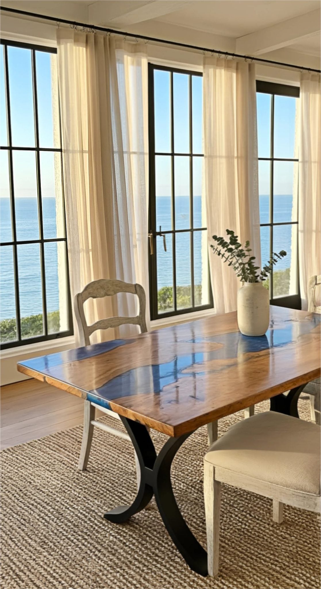Maple Burl Epoxy River Dining Table with black steel base in a bright dining room