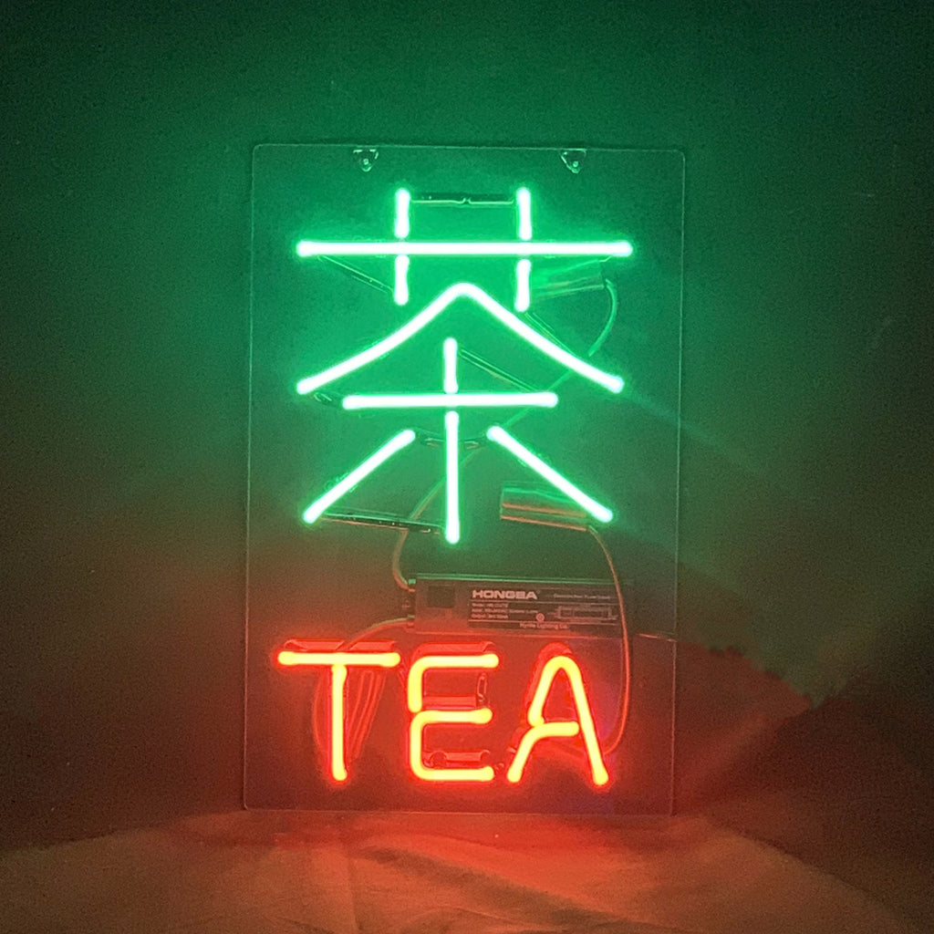 Chinese Characters Tea Neon Sign glowing in warm yellow light on an acrylic backing, hung on a wall