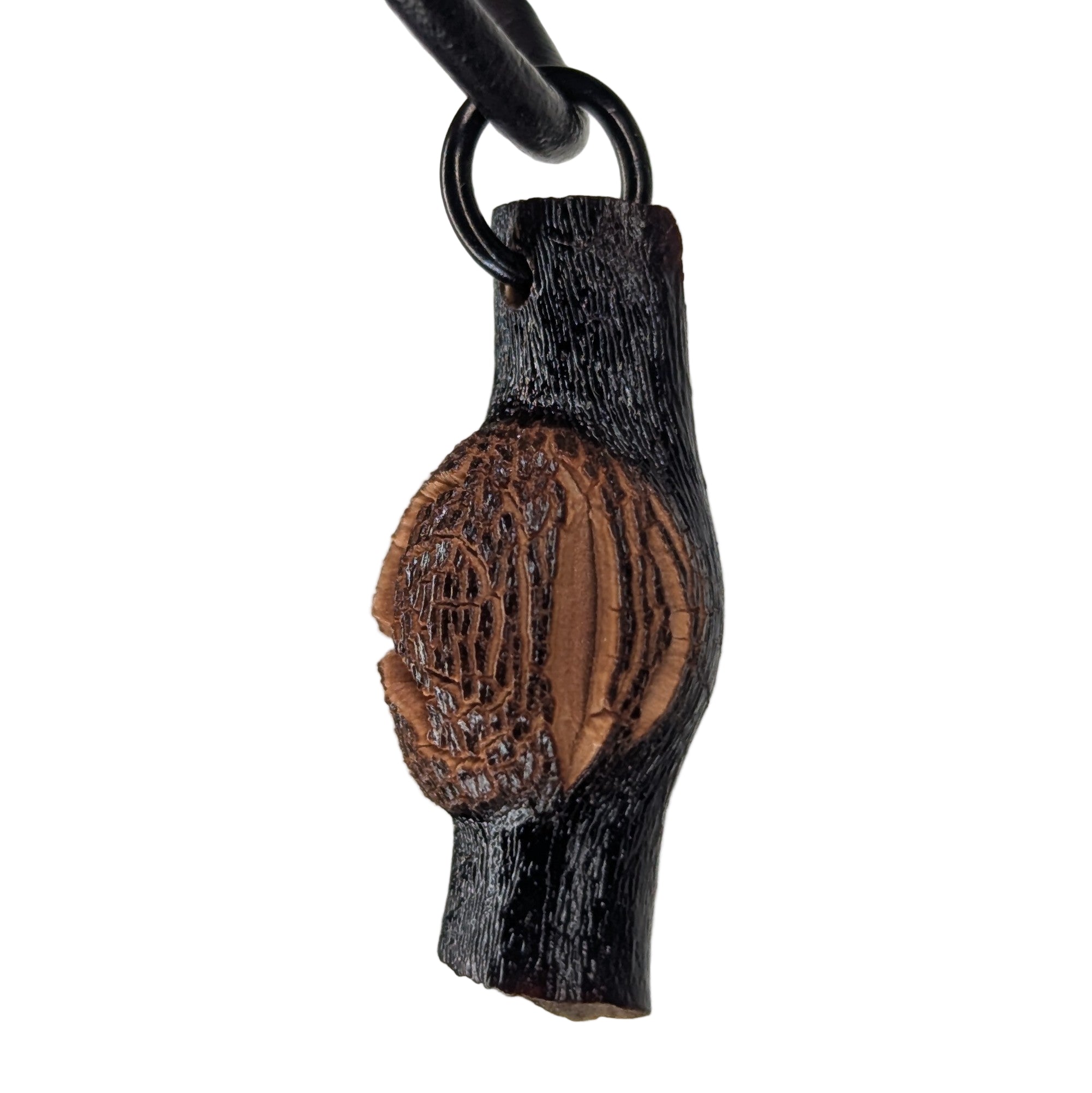 Cladira pendant necklace displayed on natural surface, showing organic texture and unique shape
