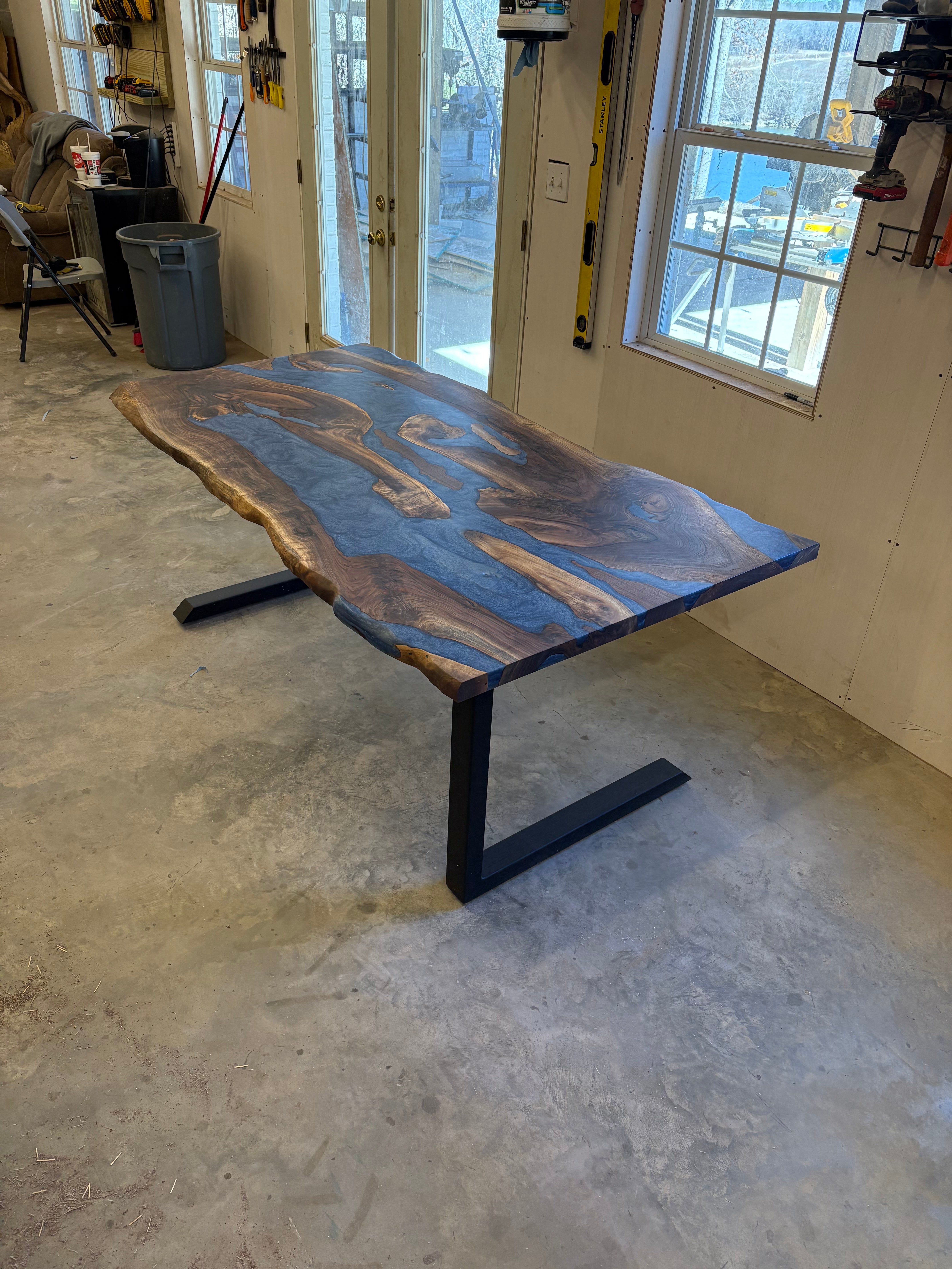 6x3 walnut river table with blue resin inlay in a workshop setting