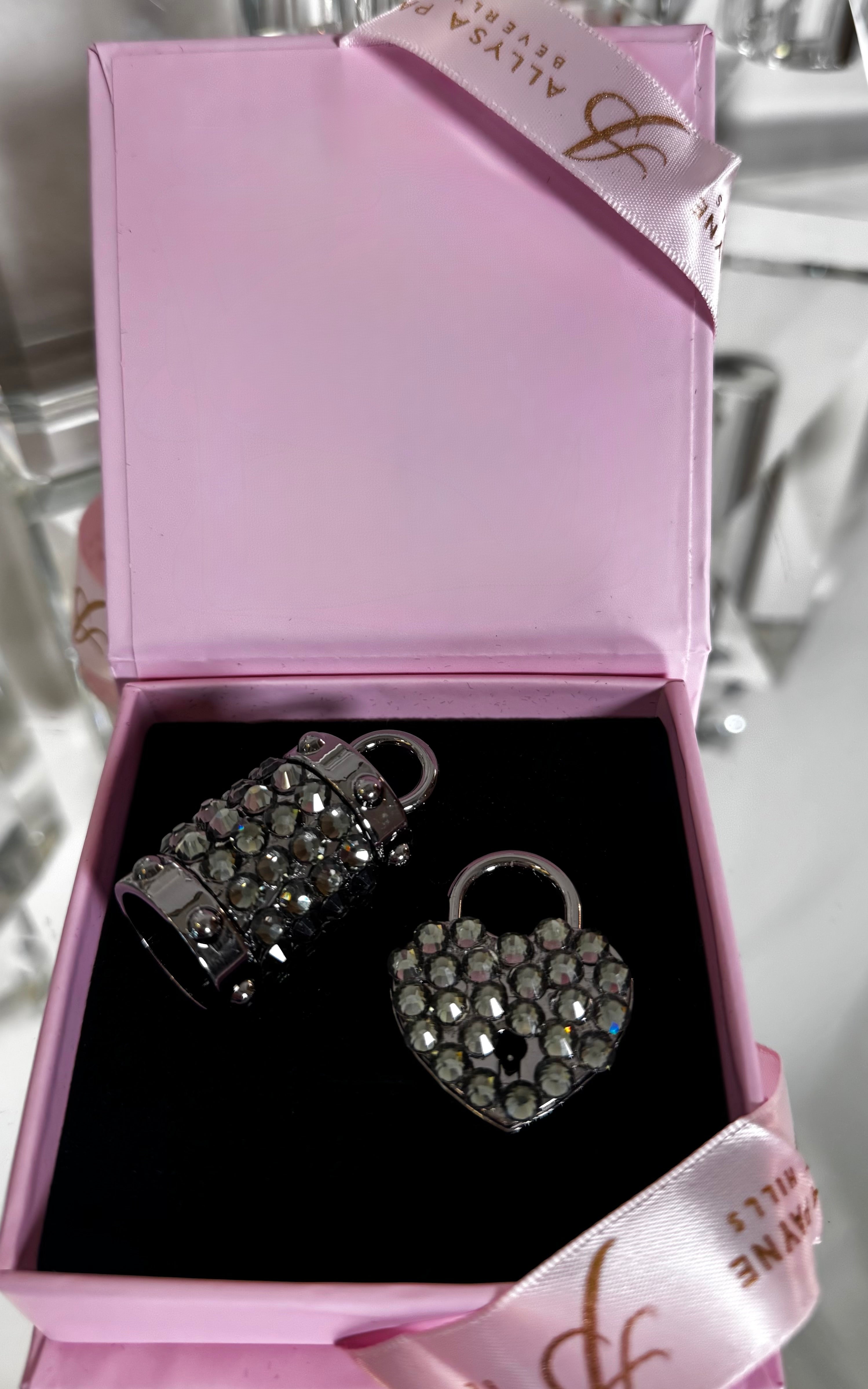 Gun Metal Swarovski Crystal Love Charm Set showing a crystal heart locket and matching bell charm on polished gun metal hardware