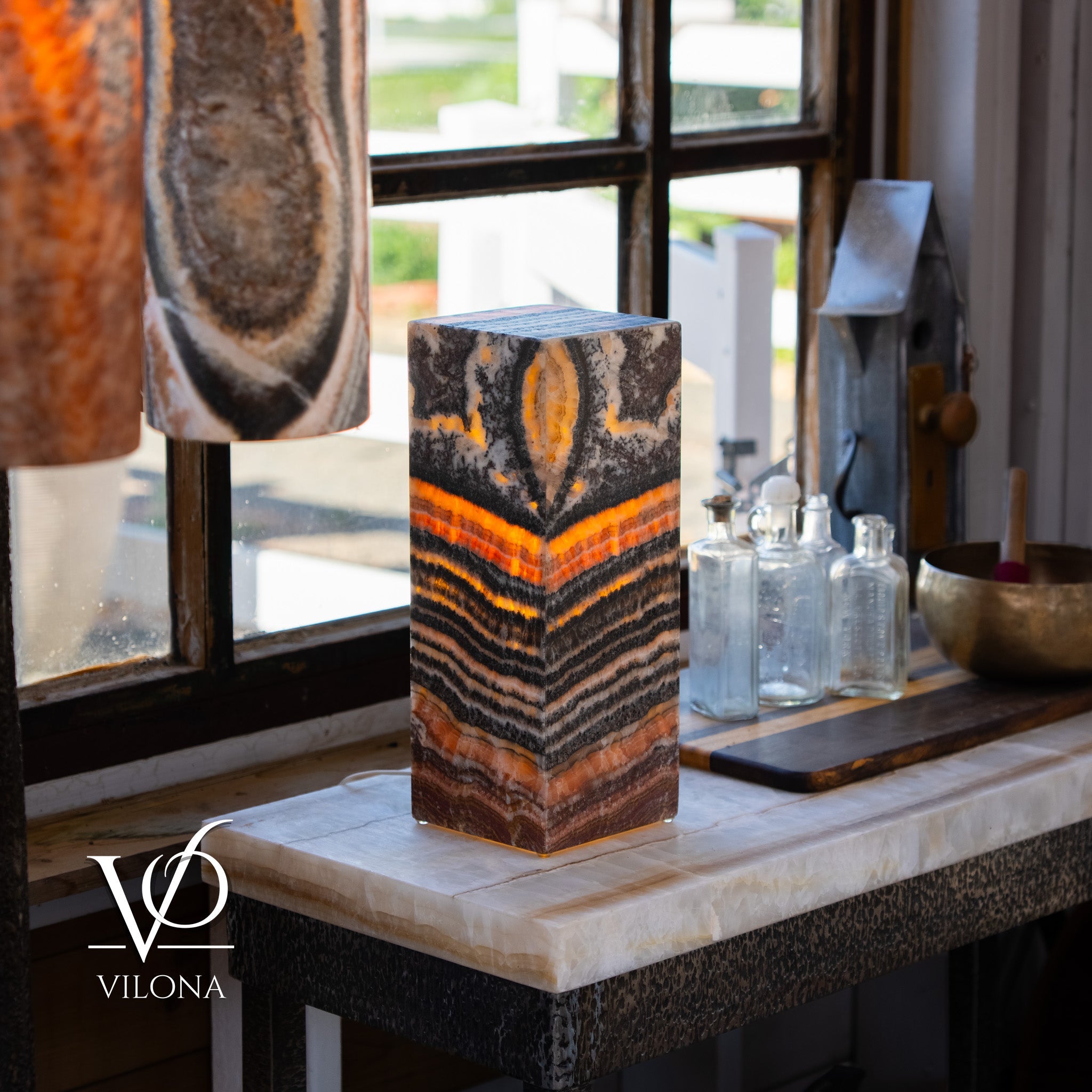 Tangerine Onyx Table Lamp with glowing orange band and layered stone pattern, 16 inches tall and square base