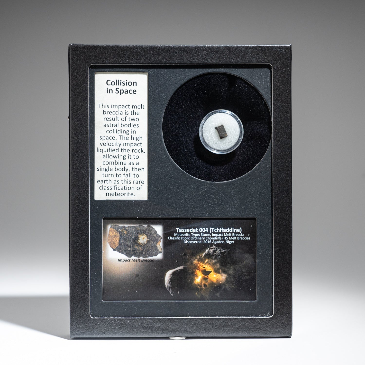 Genuine Tassédet 004 meteorite displayed in glass box with label and color image