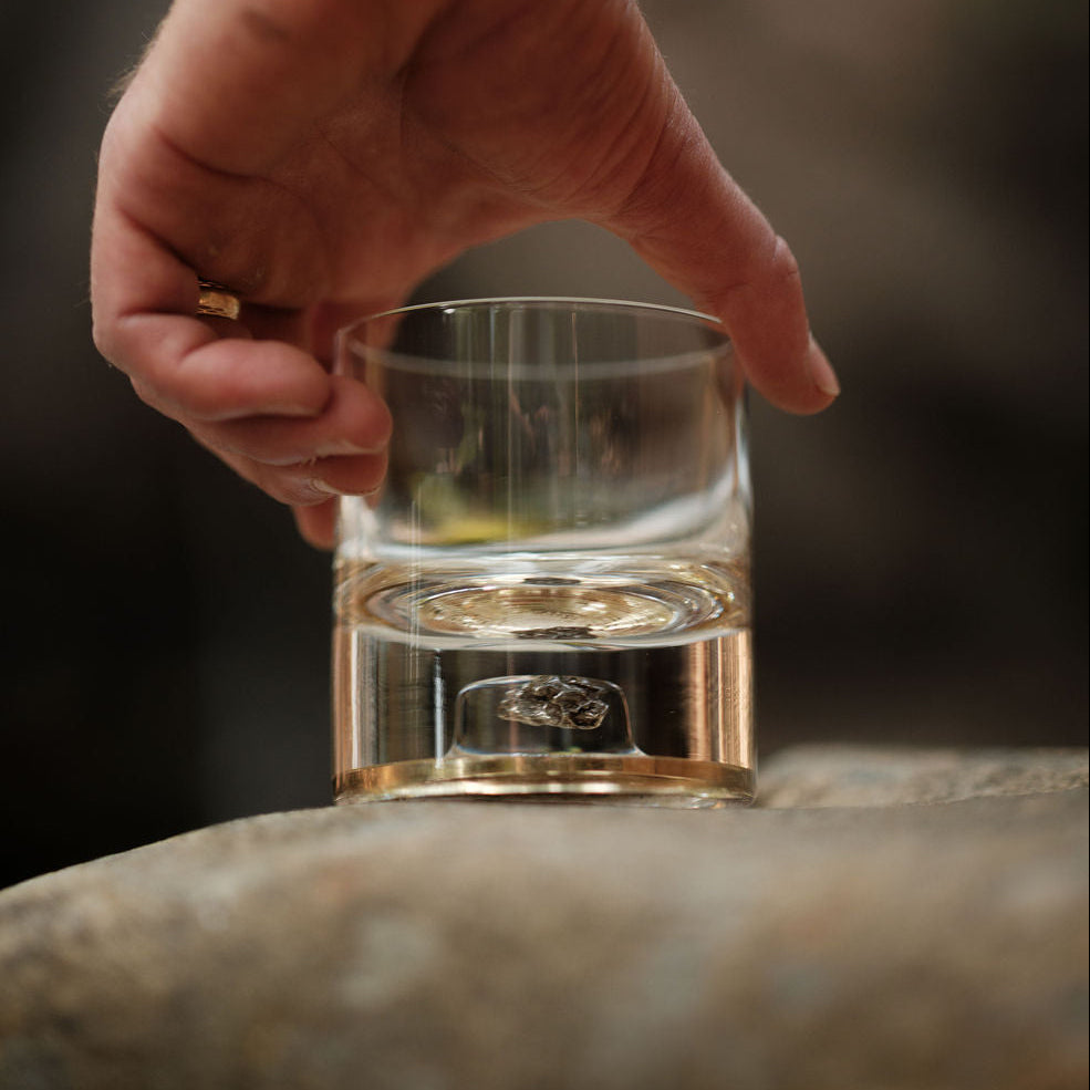 Two Meteorite Tumblers (Series V) in Antique Tin and Amber Gold with visible meteorite fragments in clear crystal base